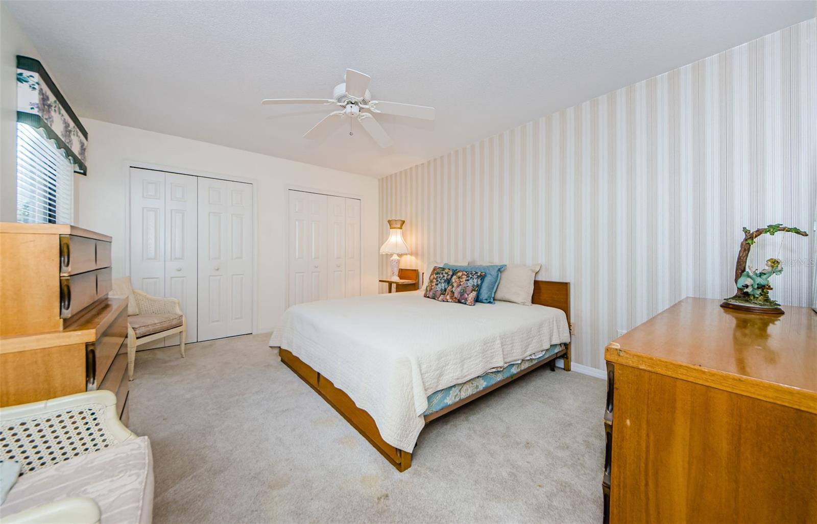 Downstairs guest bedroom with double closets. Adjacent to hall bath and laundry room.