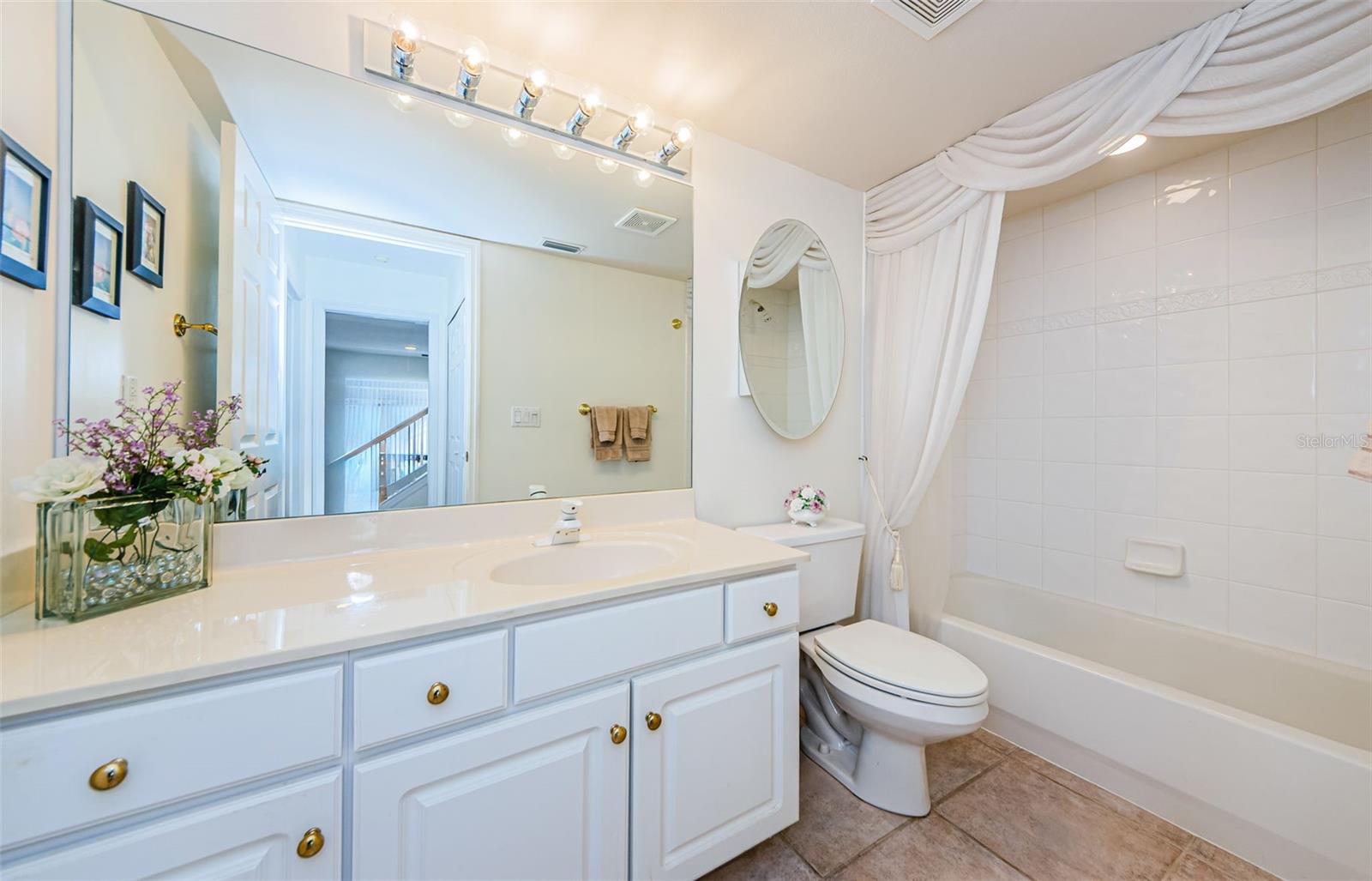 Downstairs hall bath with tub/shower and large vanity.