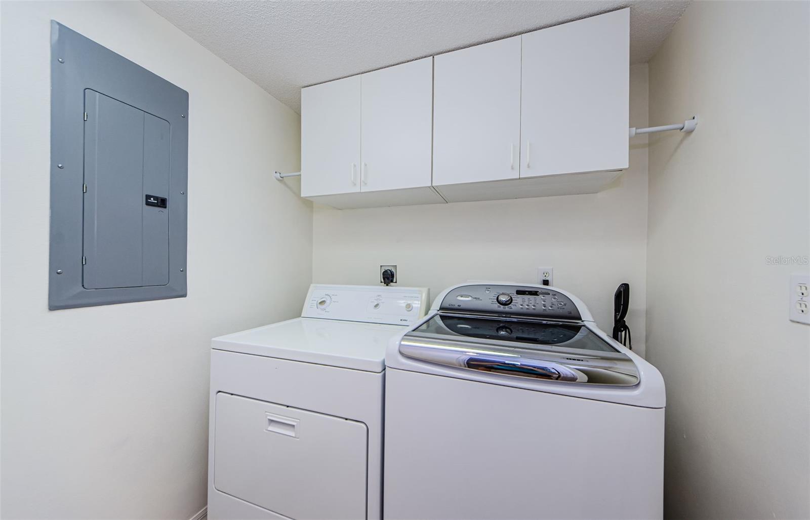 Interior laundry adjacent to the hall bath downstairs.