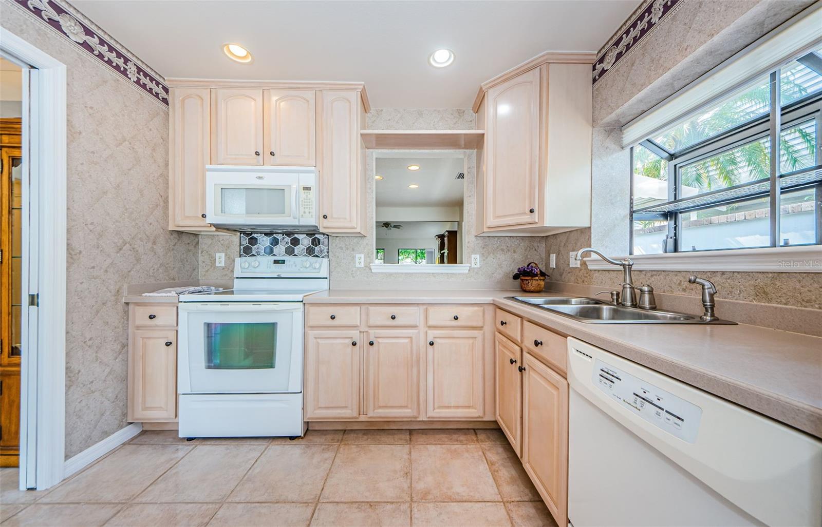 Spacious eat in kitchen and solid wood cabinets and pass thru to the dining area!