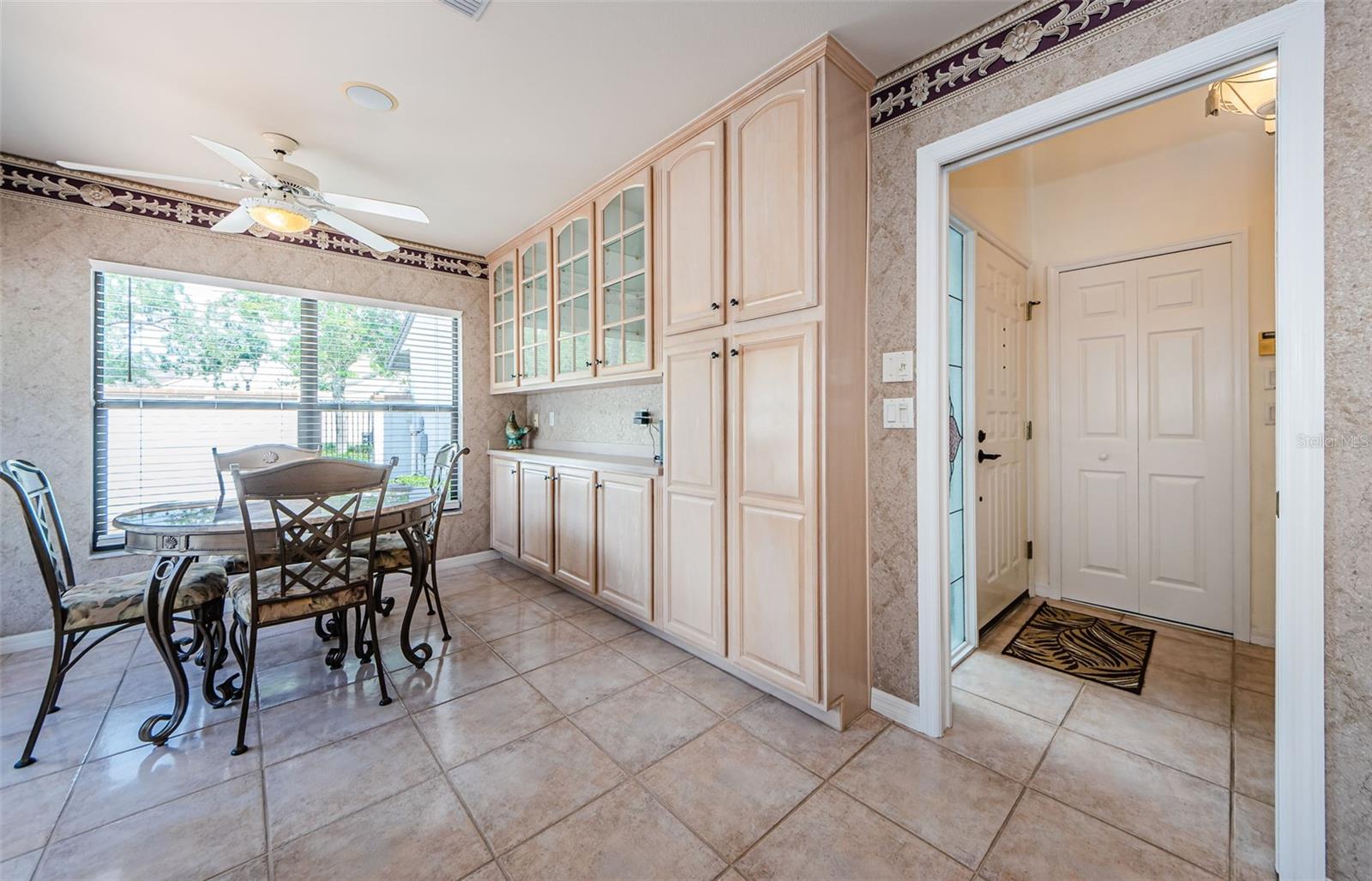 The eat in kitchen and fabulous cabinetry for all your serving pieces and  pantry items! To the right is the entry and the entry closet.