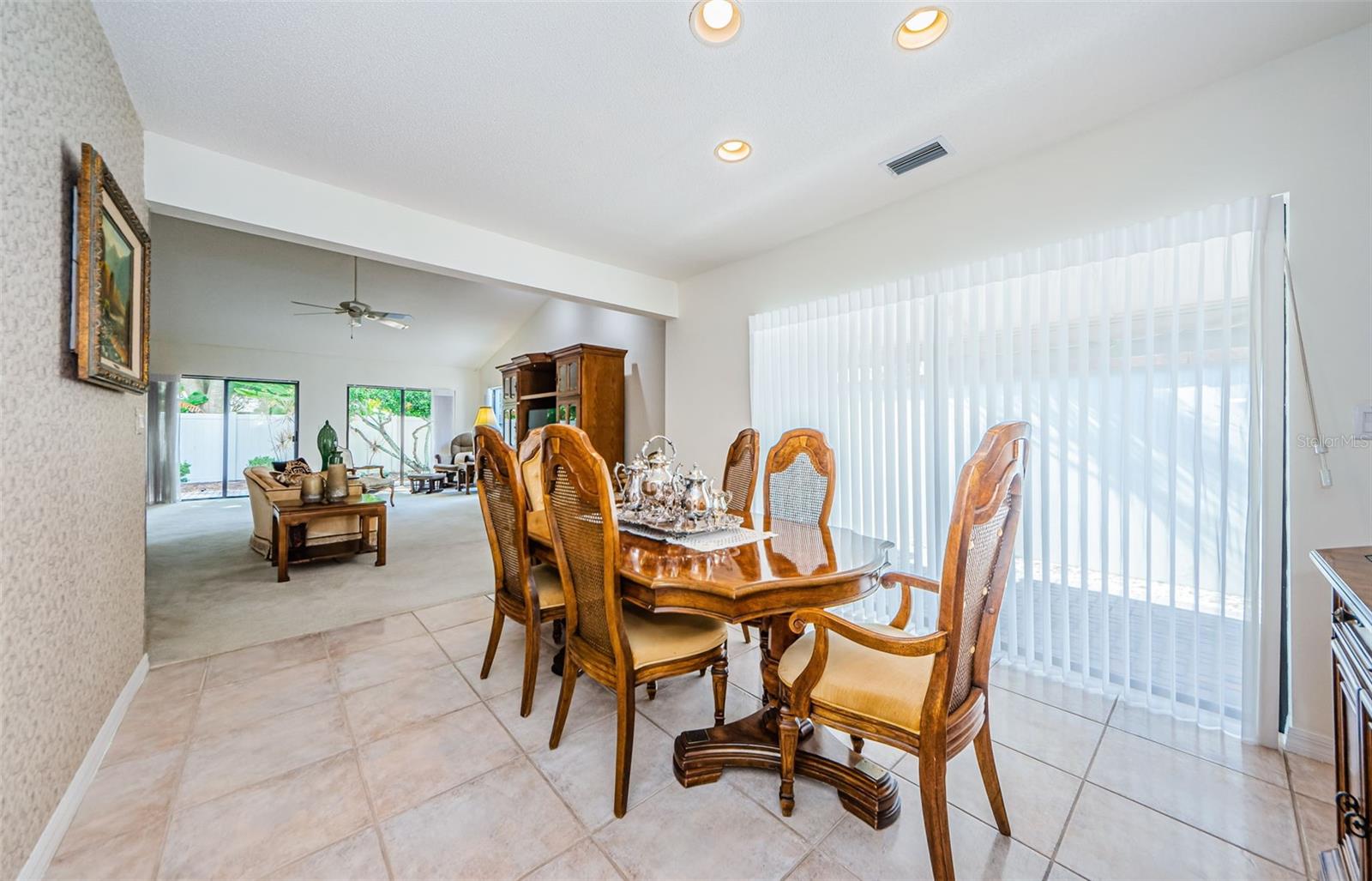 The formal dining area, opens to the living room with the vaulted ceiling! You are surrounded by natural light and your own private walled courtyard!