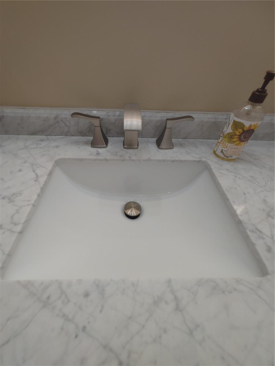 Beautiful marble countertops in bathrooms with new faucets/hardware.