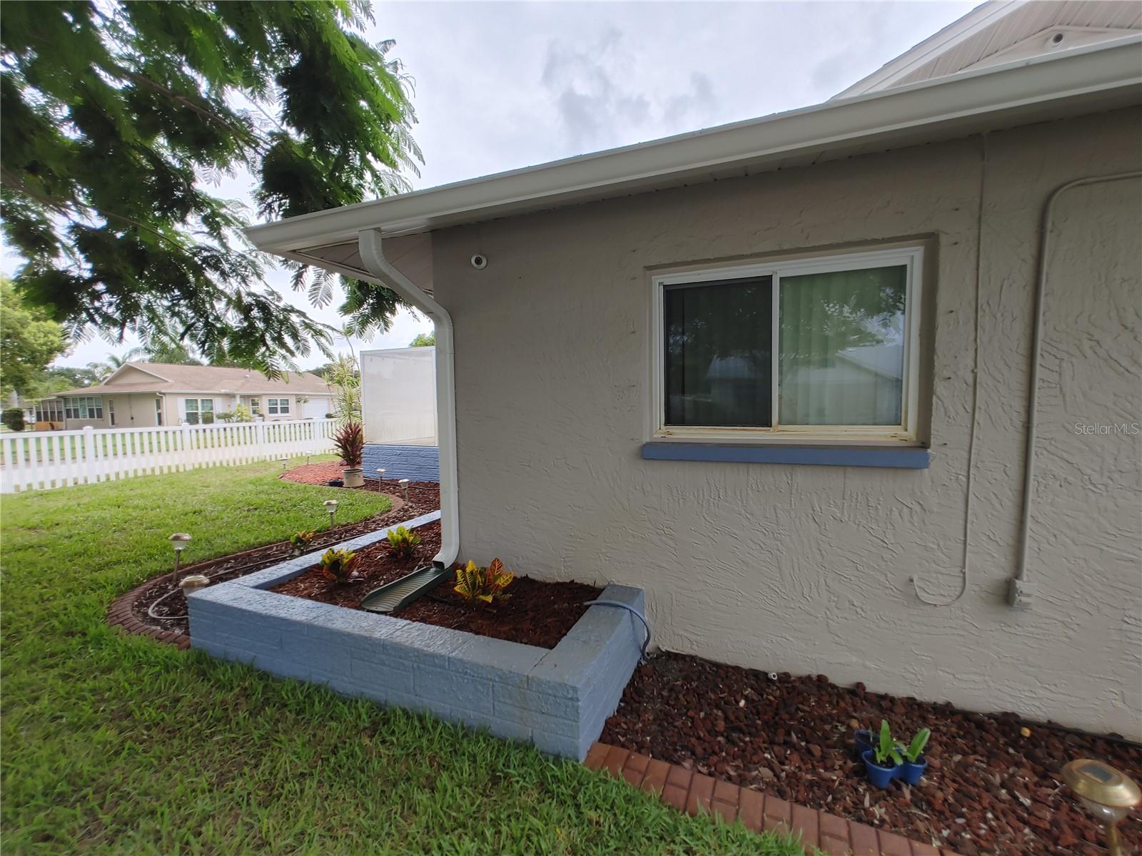 Raised flower beds with irrigation system, freshly laid sod and curb appeal.  Nice!