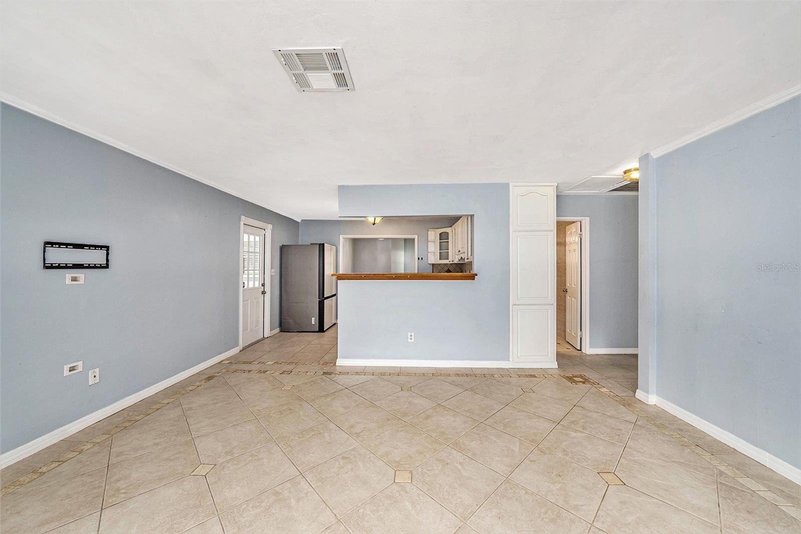 Carport with covered entries to living room, laundry room, and kitchen.