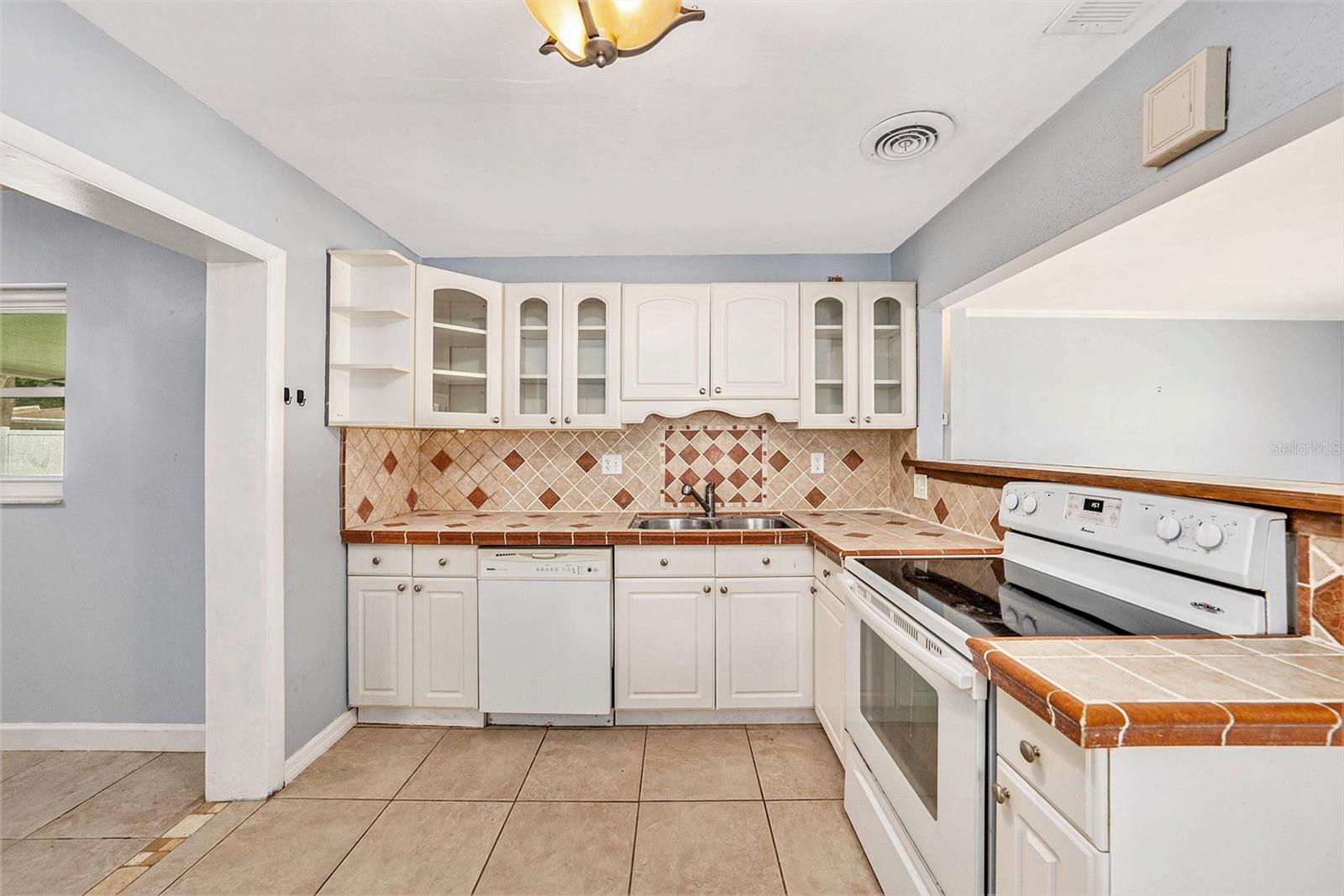 Kitchen is open to living room on one side and dining room on the other.