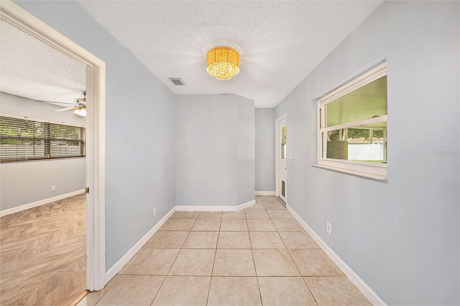 Just off the kitchen is the dining room with access to the screened lanai and massive backyard.