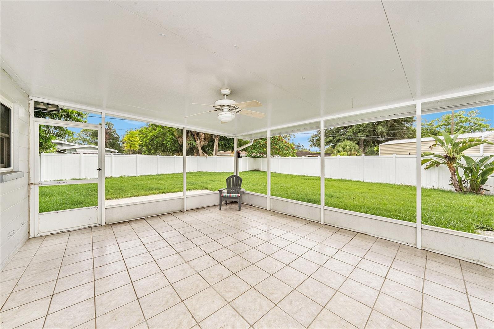 Fantastic 300 sf screened-in tiled lanai with ceiling fan - perfect for enjoying the Florida outdoors in comfort.