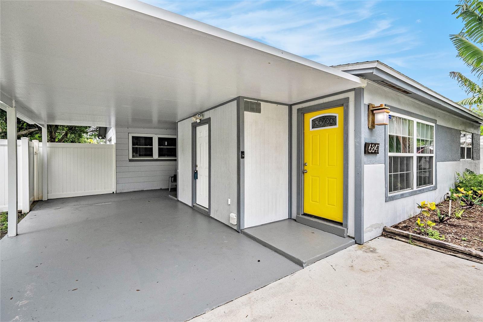 Carport with covered entries to living room, laundry room, and kitchen.