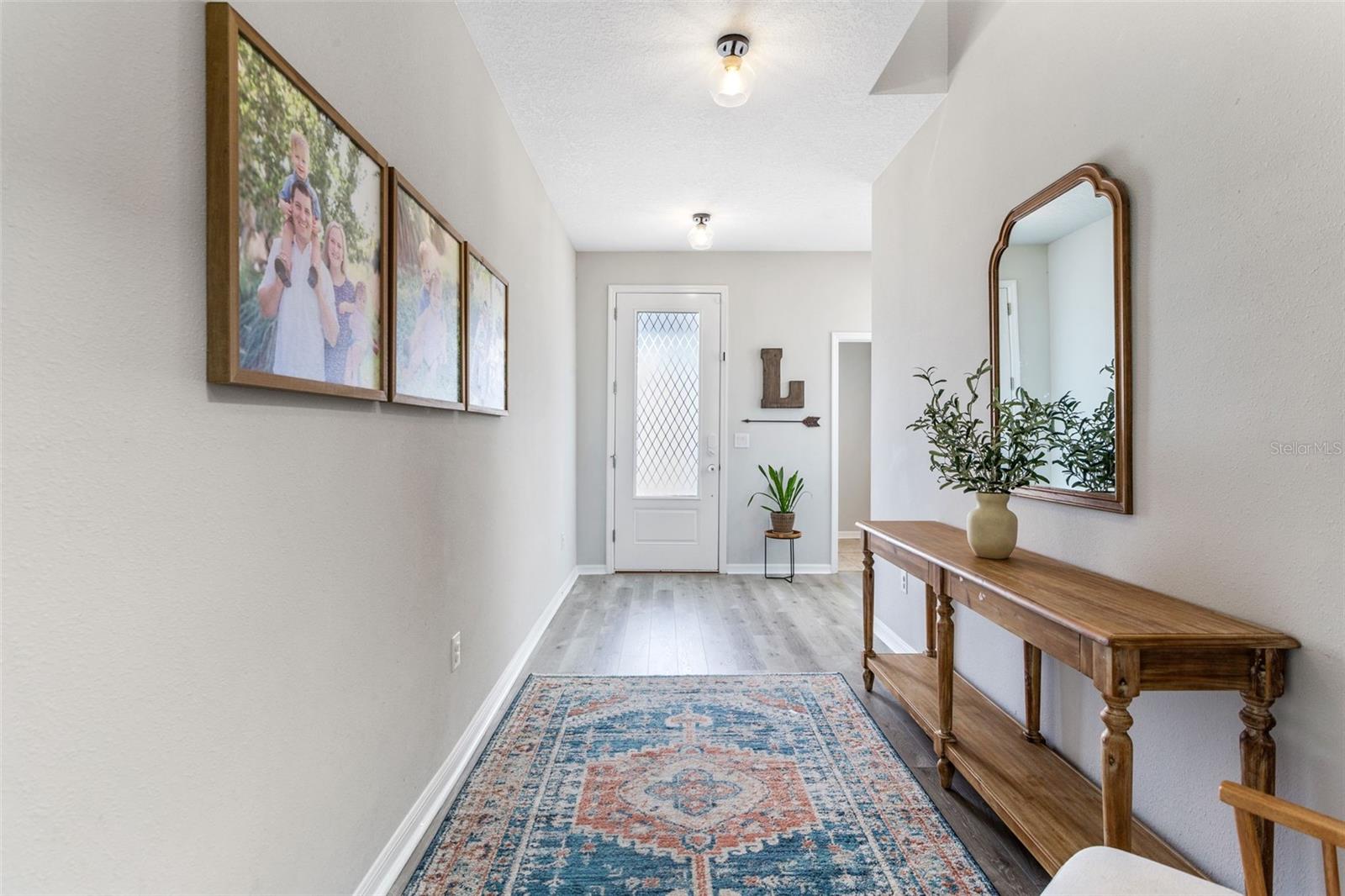 Foyer looking back towards entry. Half bath to the right of door