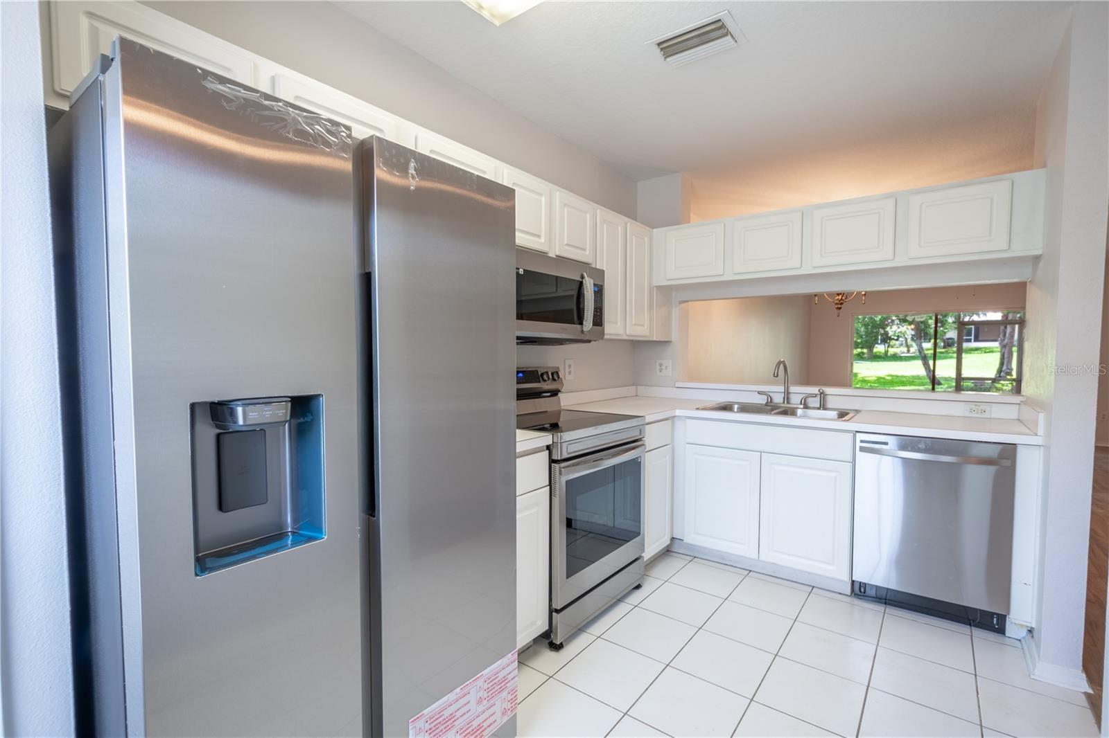 The kitchen features ample cabinets for storage needs.