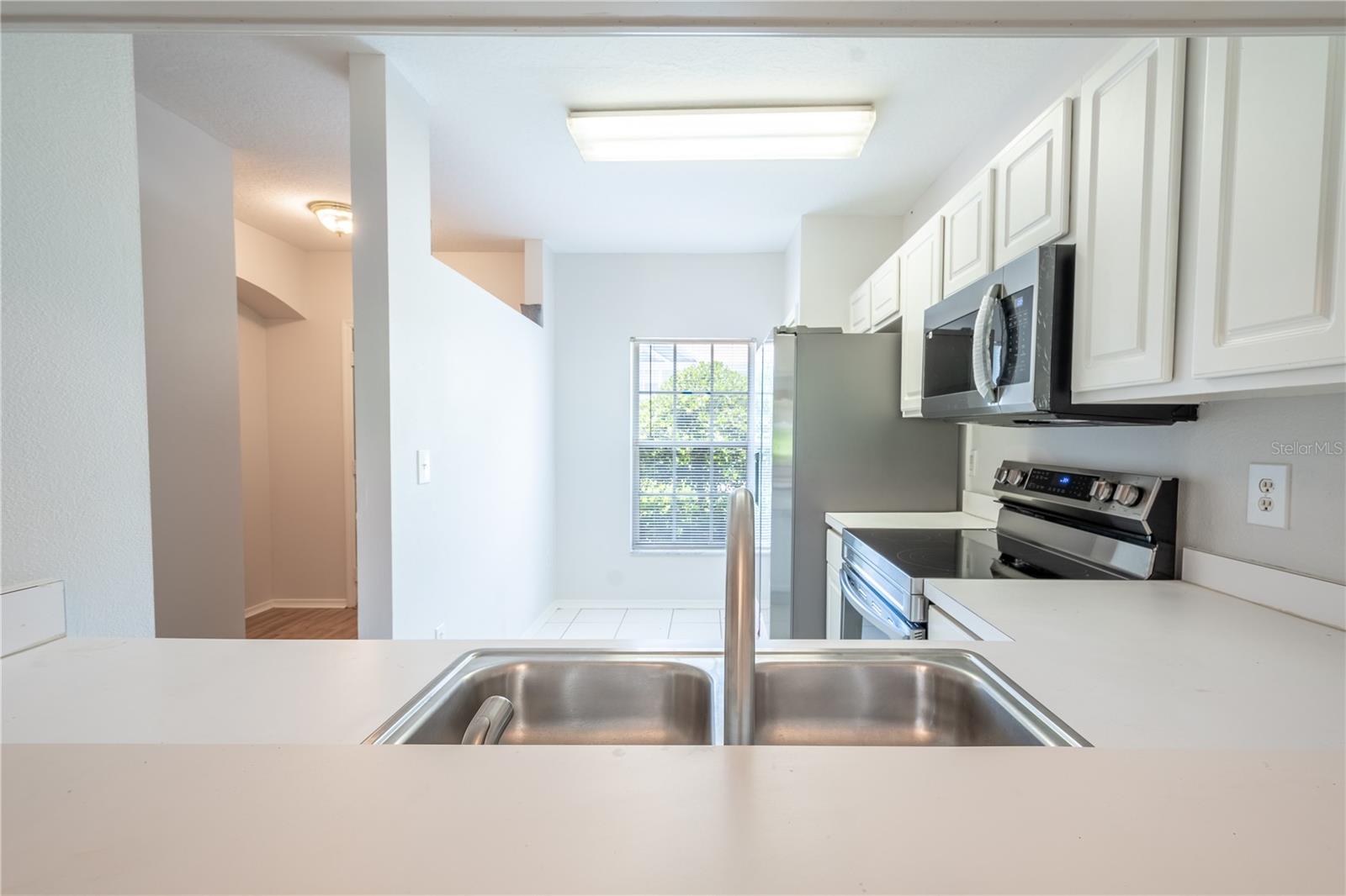 The kitchen features a double basin, stainless steel sink.