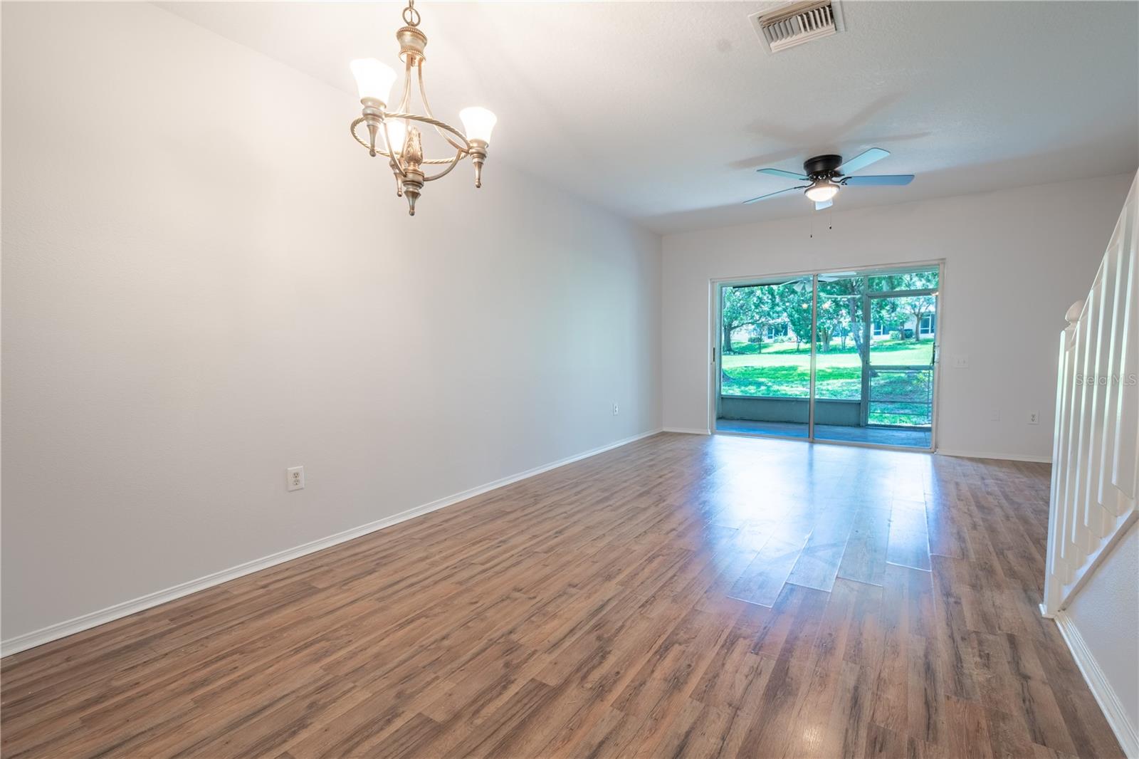 The dining area features a bress chandelier and is open to the living room.