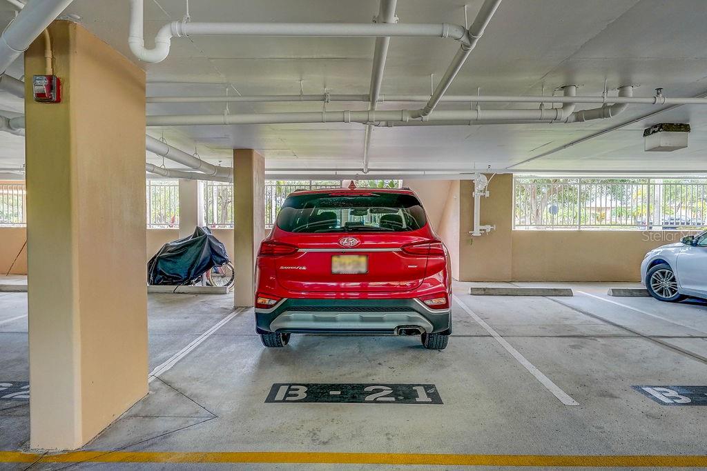 PARKING SPACE DIRECTLY UNDER UNIT WITH STAIRS LEADING TO FRONT DOOR.