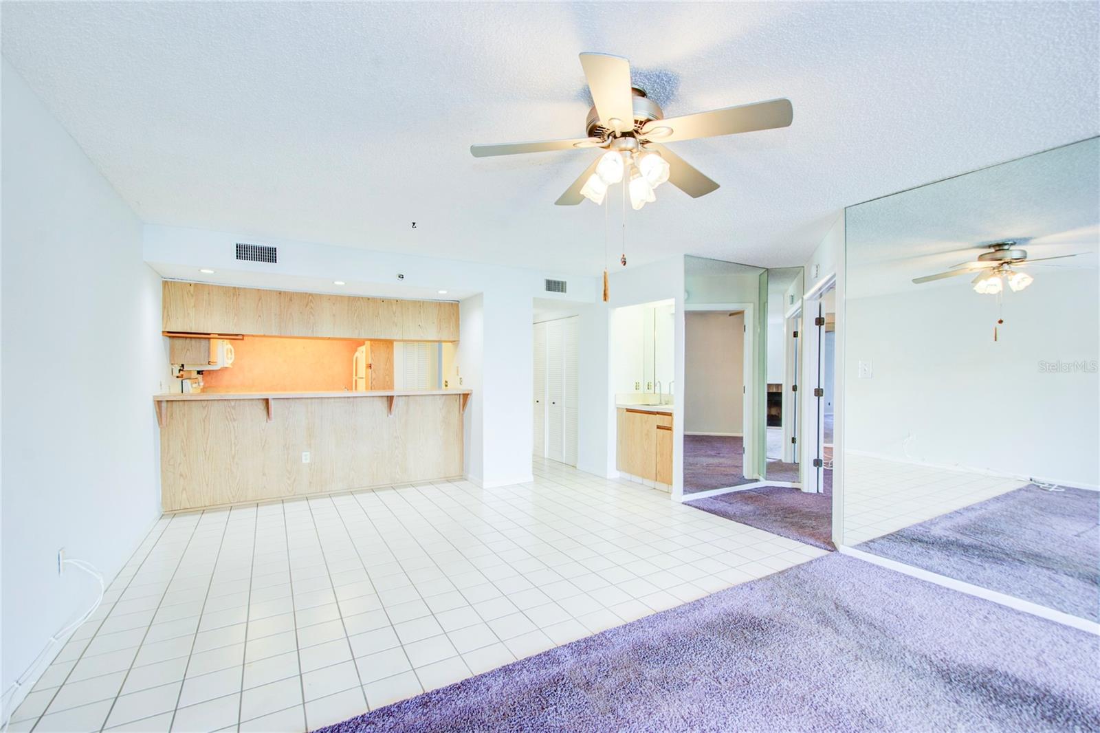 Tiles Dining Area with bar and wet bar seamlessly flows into carpeted living area "open floor plan".