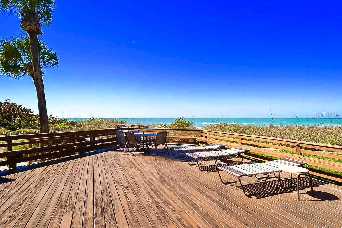 Beach front raised wooden deck - just 1 of 3 distince seaside outdoor spaces for lounging & dining.