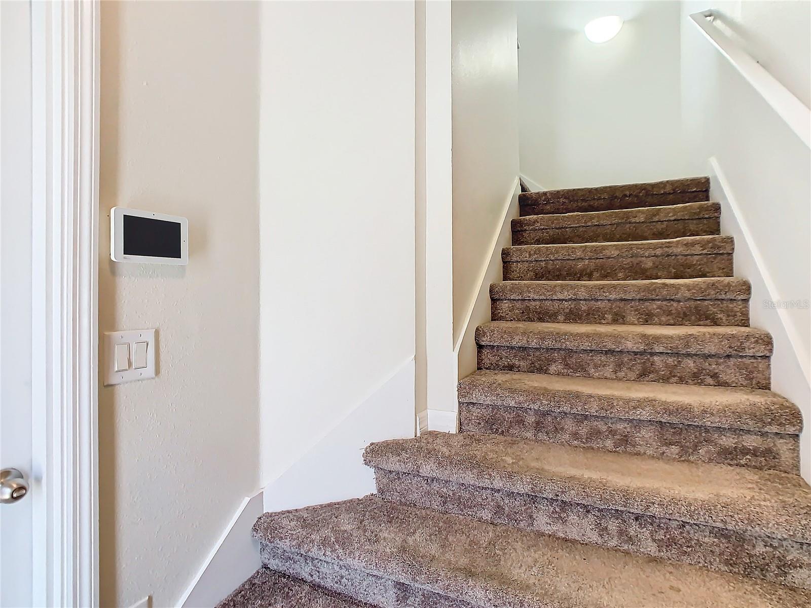 GARAGE AND MAIN DOOR ACCESS TO INTERIOR STAIRS