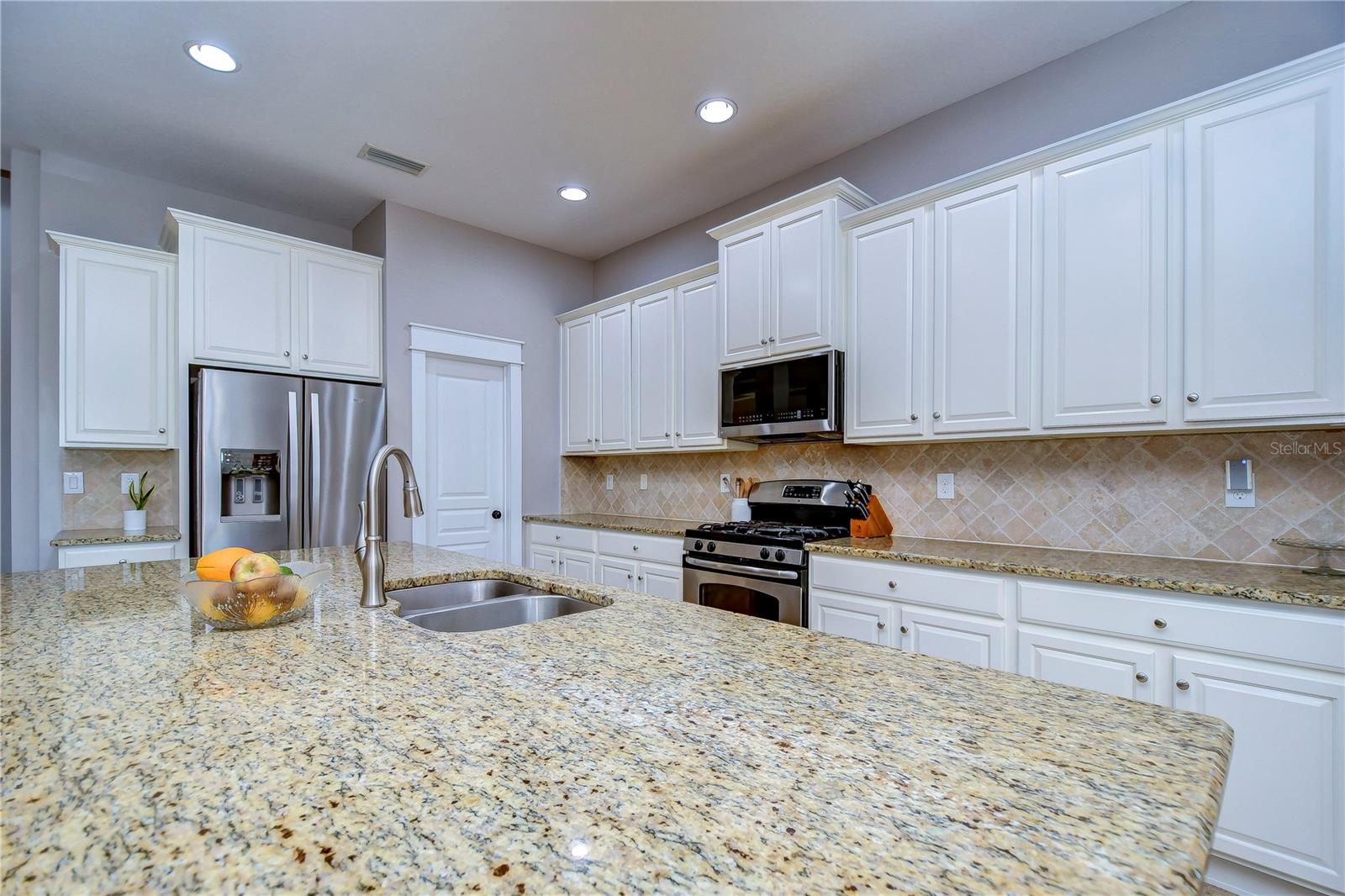 Huge island with breakfast bar seating and a double basin sink!