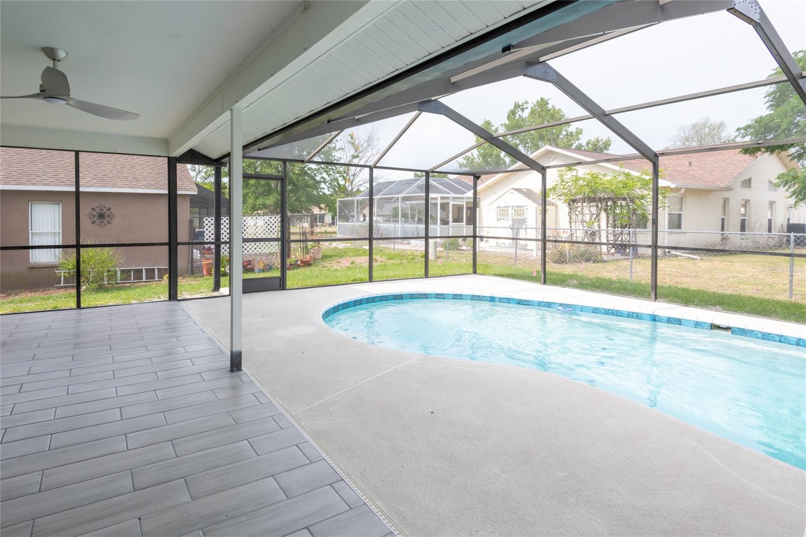 Newly retiled and resurfaced pool and tiled patio