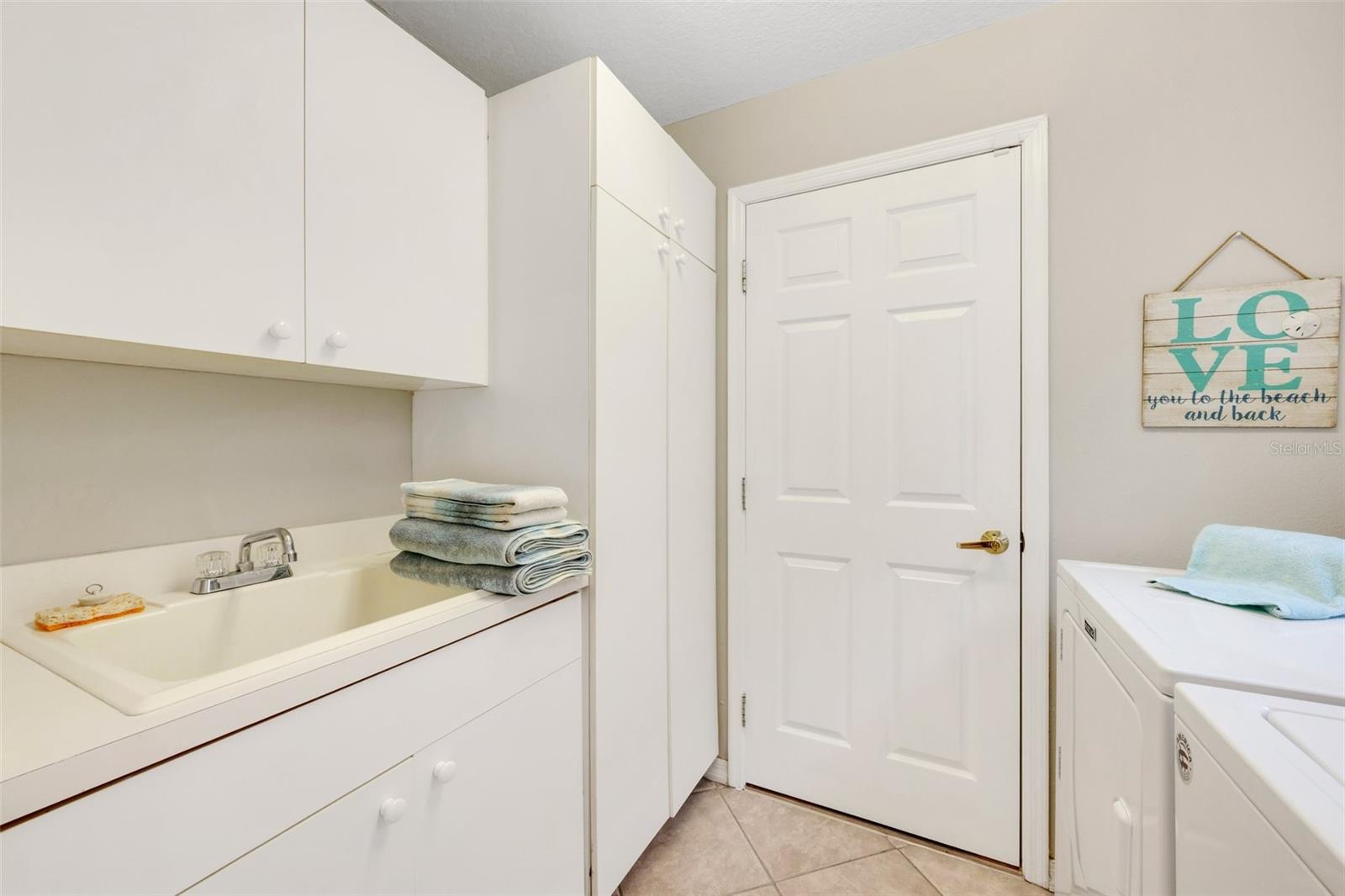 Sink and storage in the inside laundry, leads to garage!