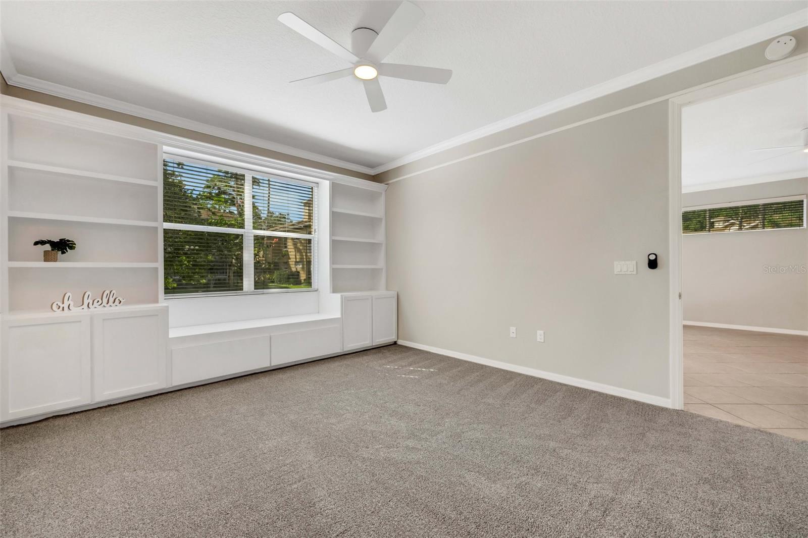 Primary bedroom features built-in shelves