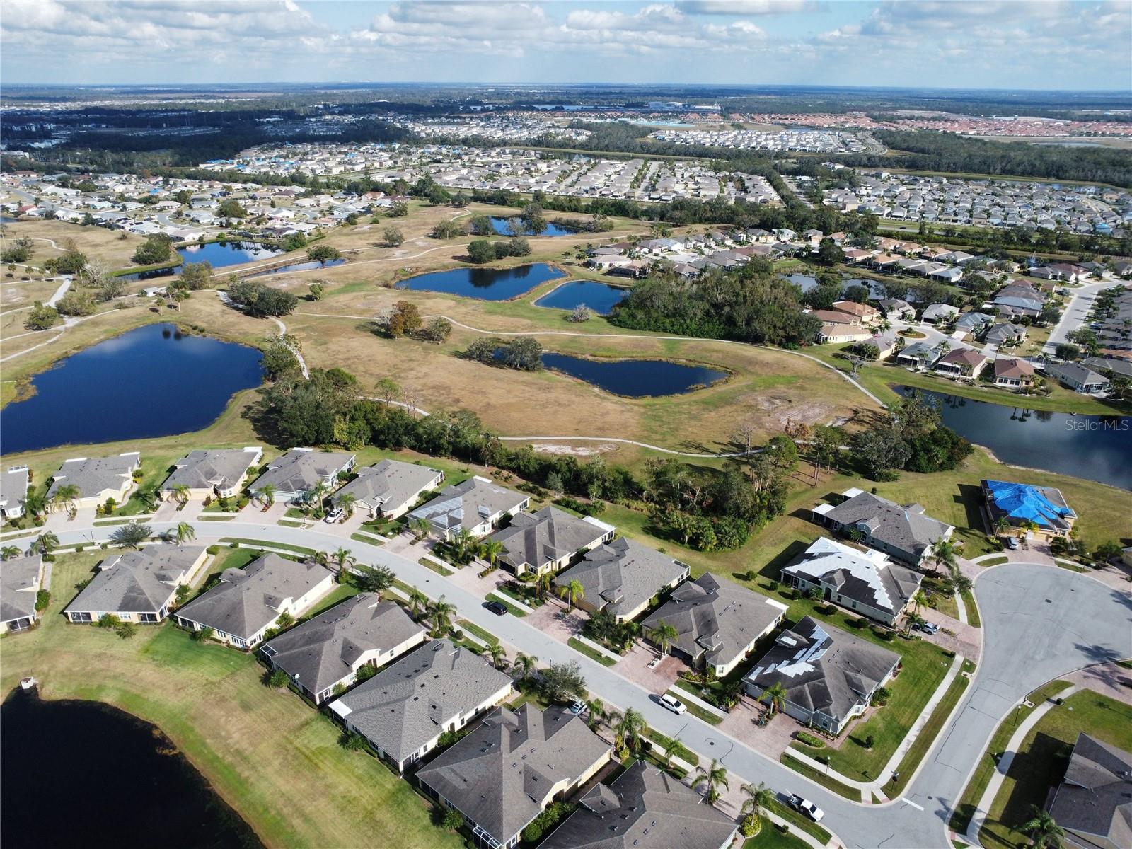 Aerial prior to roof change showcasing the lot.