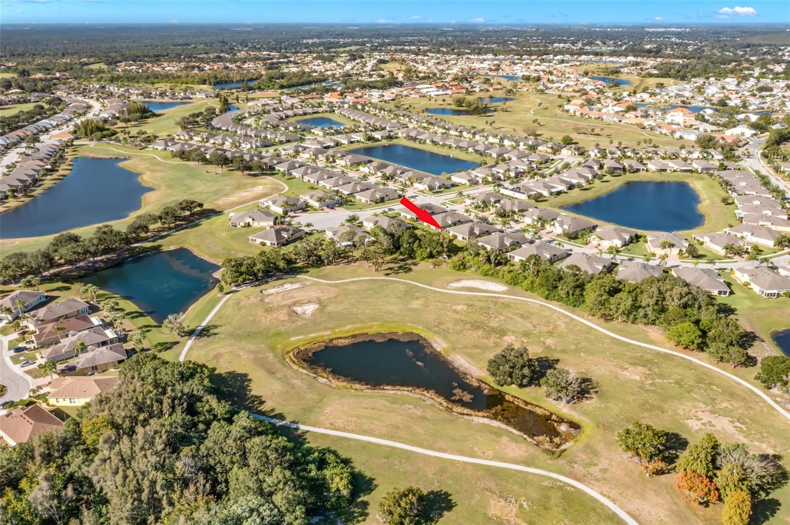 Aerial prior to roof change showcasing the lot.