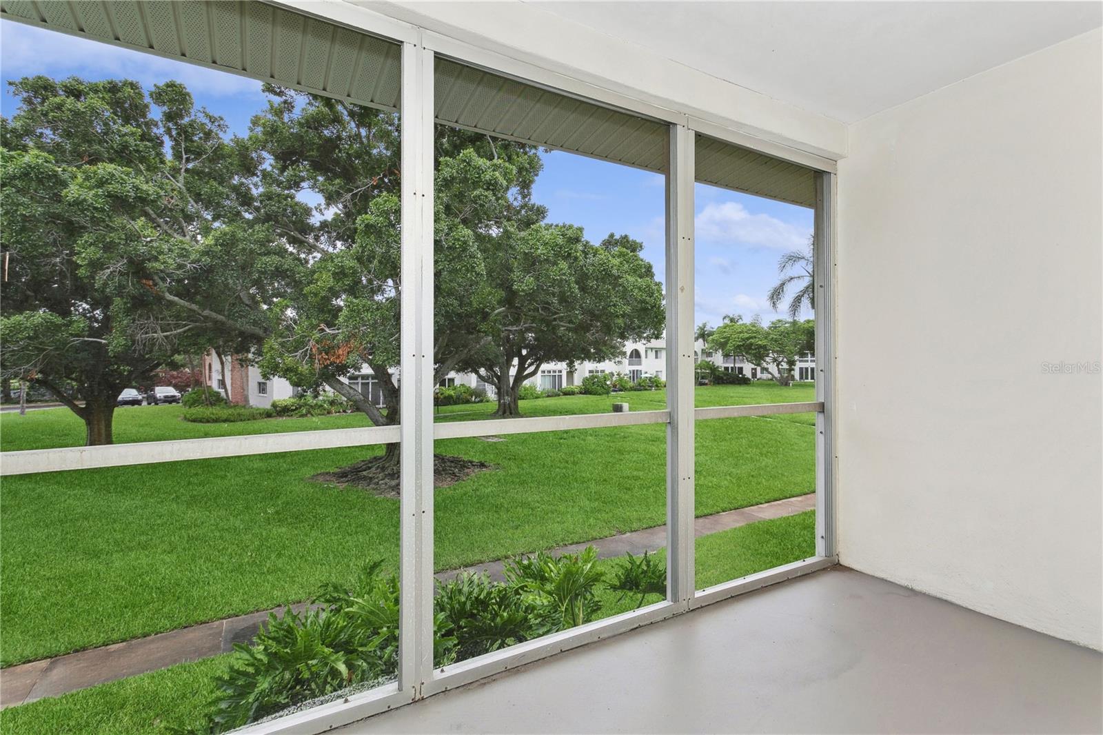 Screened in balcony overlooking the community's green space