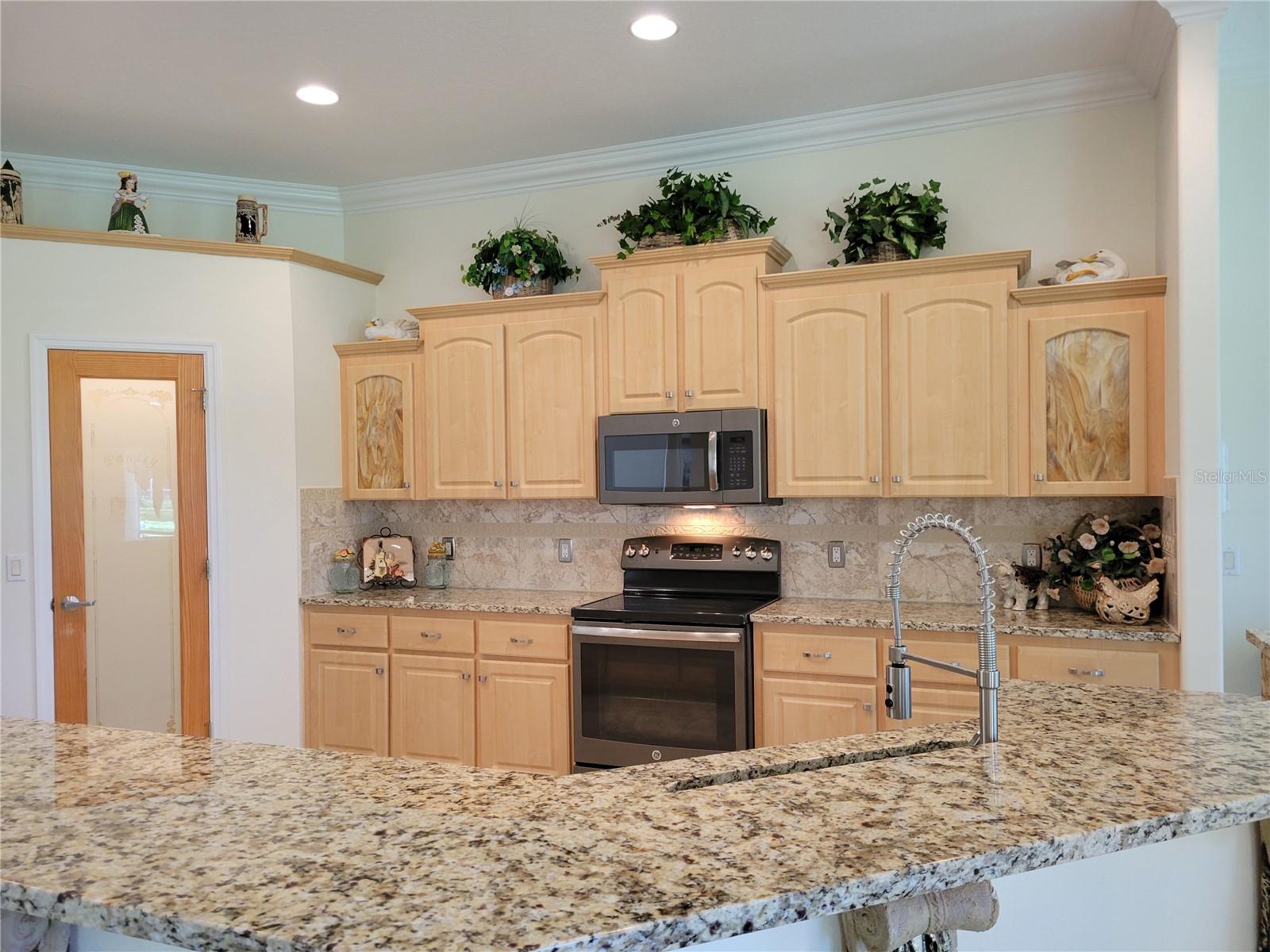 View into Kitchen from Eat-in Area, showcasing Custom Features