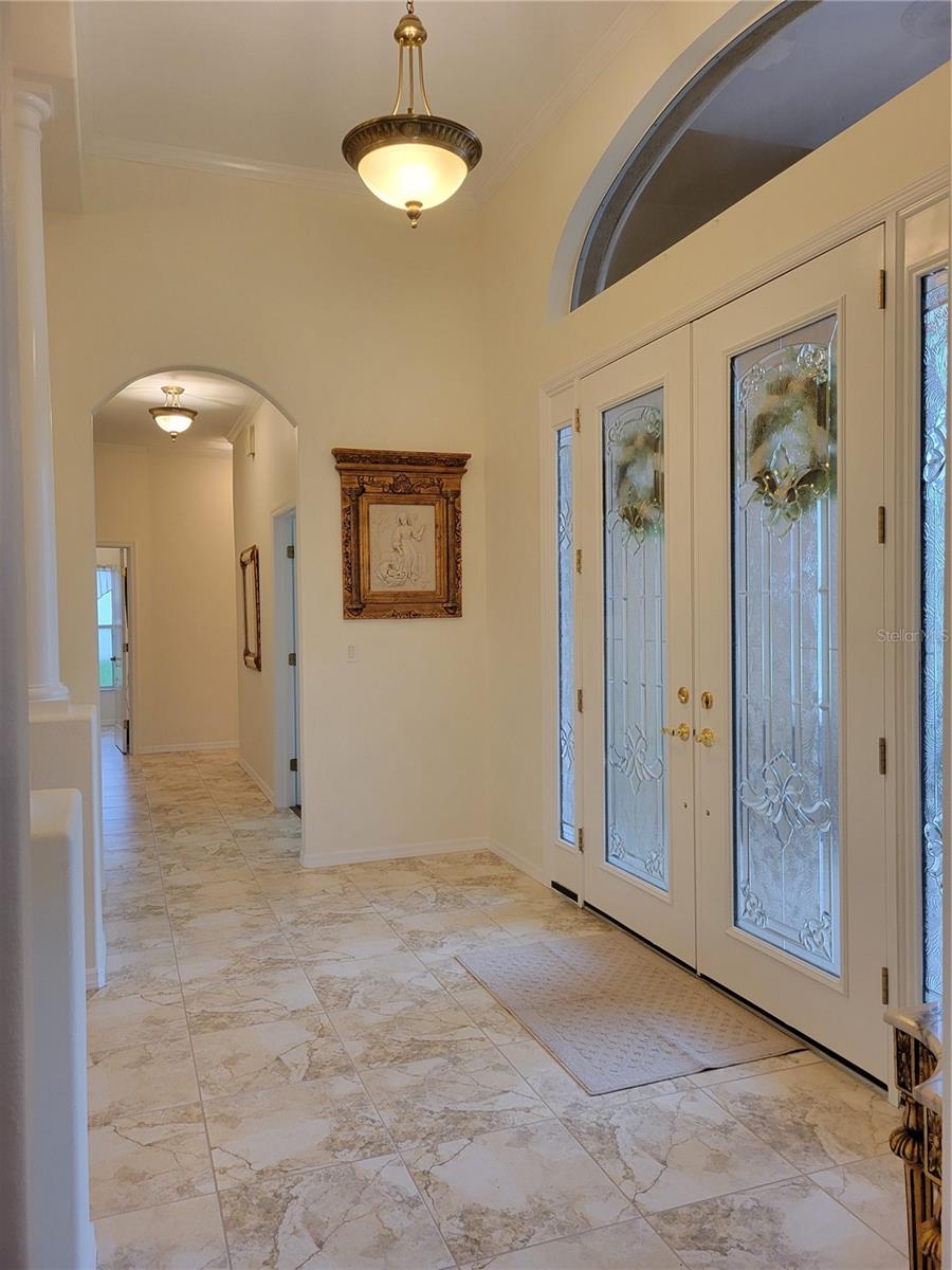 Long View of Entry Foyer with 12' Ceiling that runs from the Formal DR to the Bedrooms, Secondary Bathrooms & Laundry.  (Note that the Master Suite is at the back of the house, the 2 secondary BR's are at the front.)