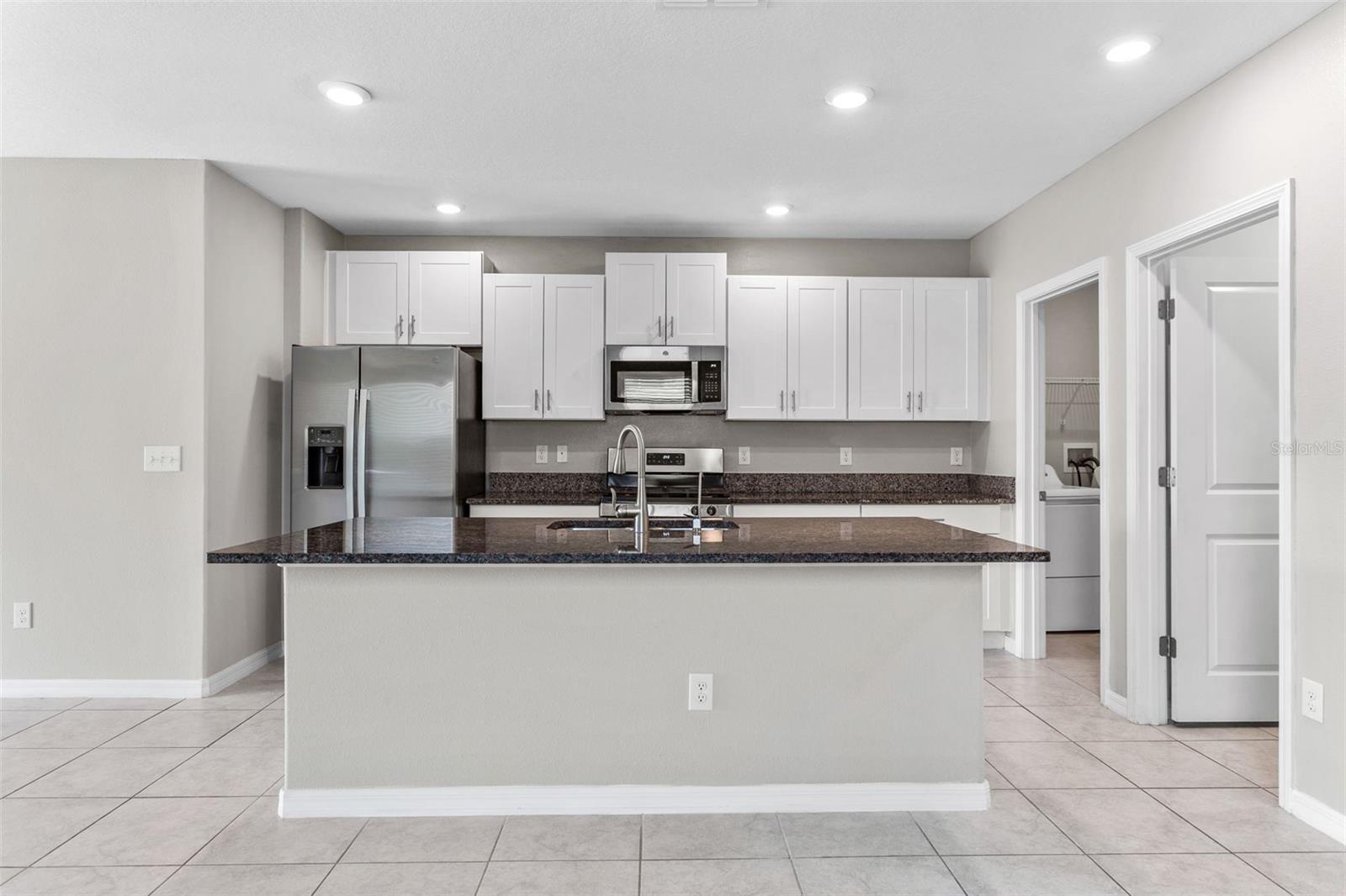 Kitchen with natural gas stove and stainless steel appliances