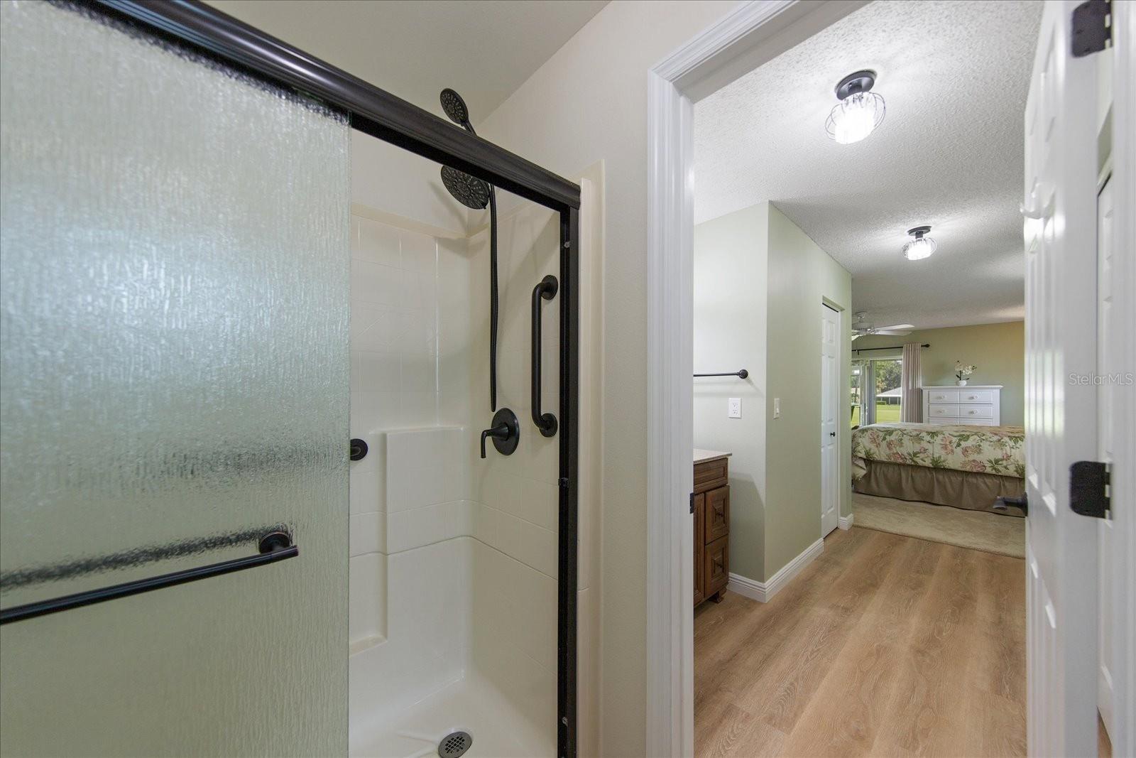 Private water closet with newer step in shower with safety features~