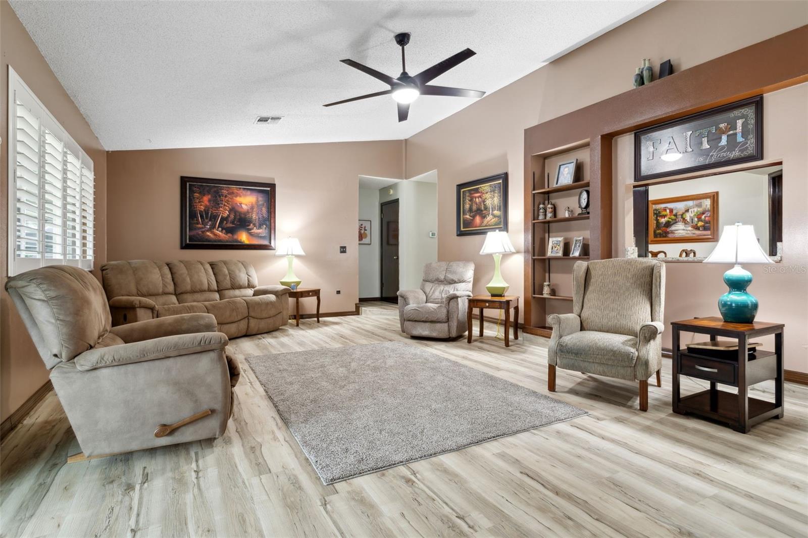 Family Room w/ updated ceiling fans and Plantation Shutters