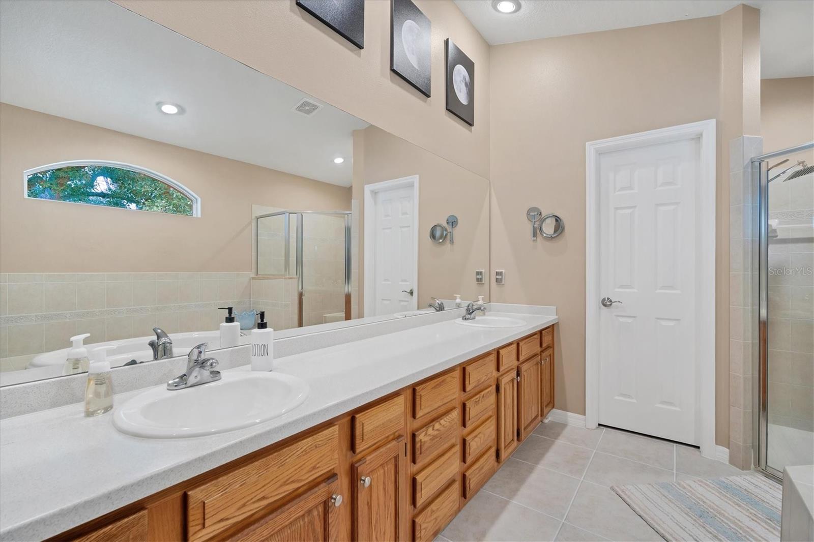 Corian countertops on this large dual vanity.  Look at all those cabinets and drawers too!