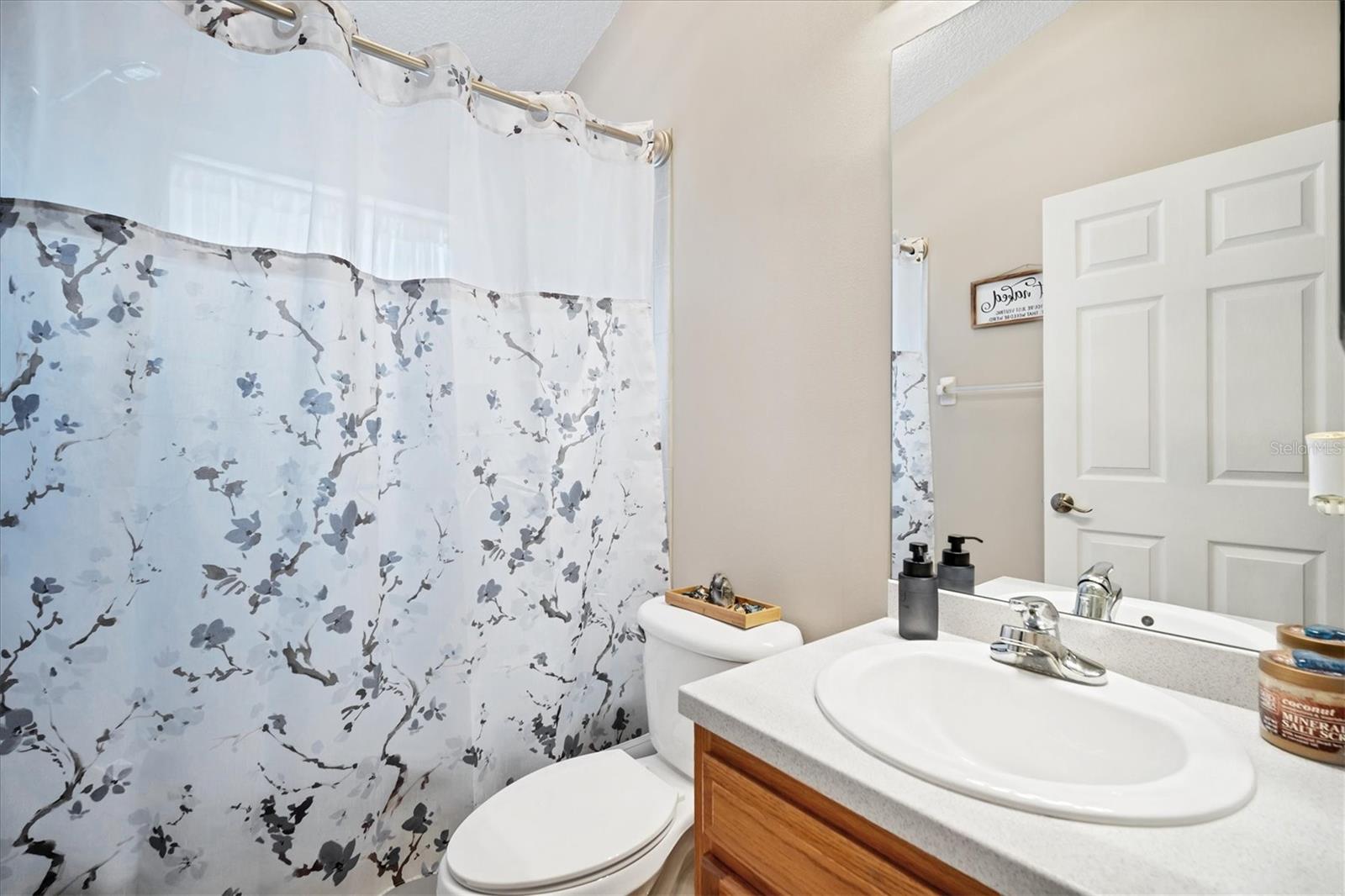 Front bathroom also features Corian countertops and a versatile tub/shower combo