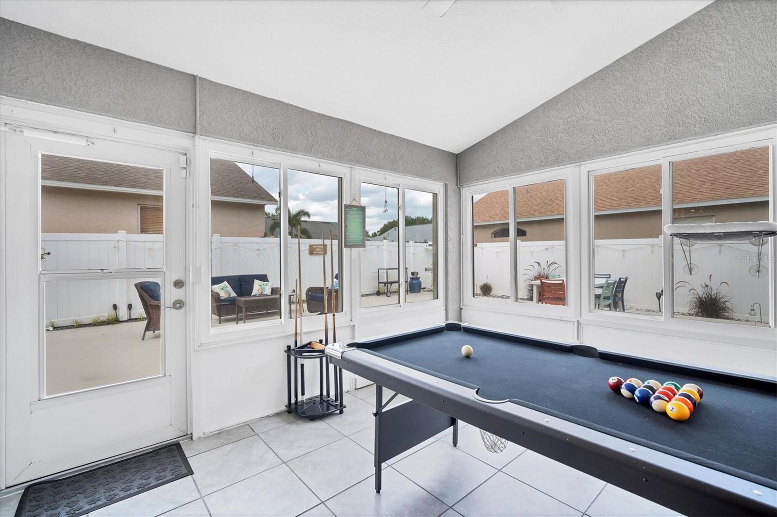 Enclosed Florida Room located at the back of the house currently set up as a game room (pool table included!)