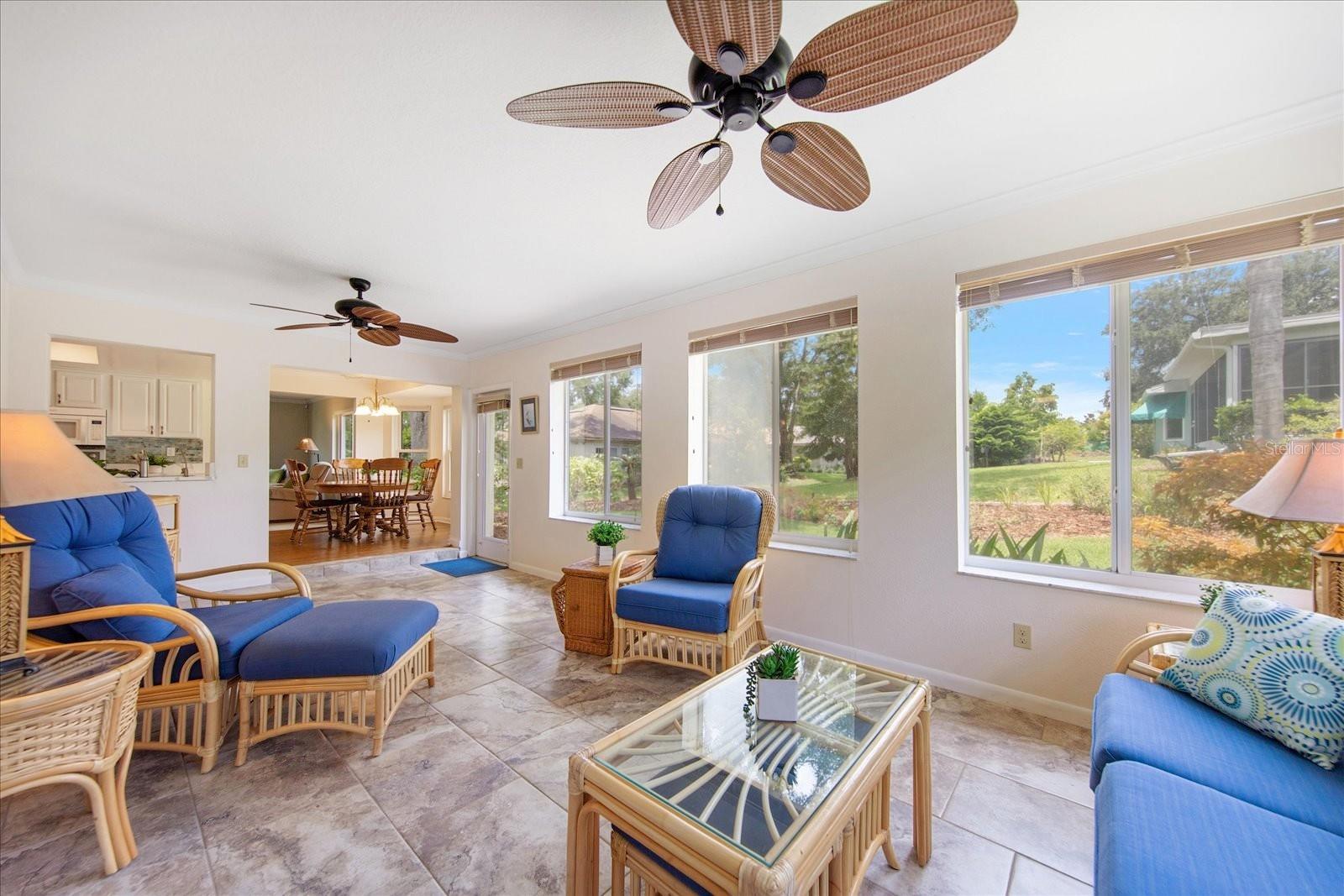 A tropical year-round family room with backyard patio access~