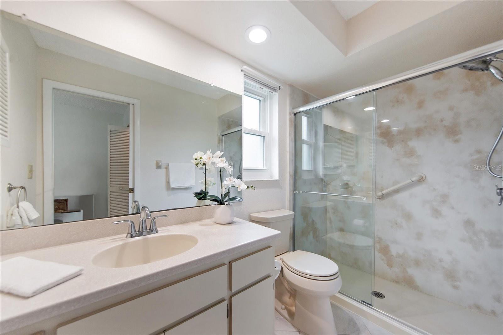 The ensuite with newer step-in shower, floor, & fixtures~