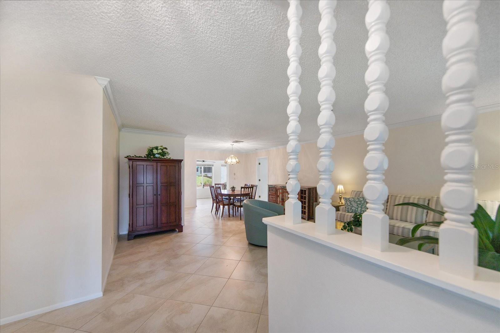 Updated diagonal travertine-look tile in the foyer, living, & dining room~