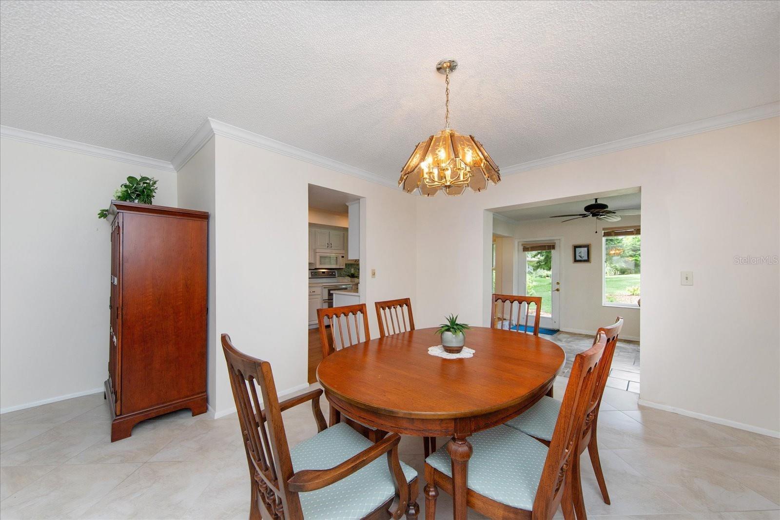 Dining area opens to kitchen and the year-round Florida room~