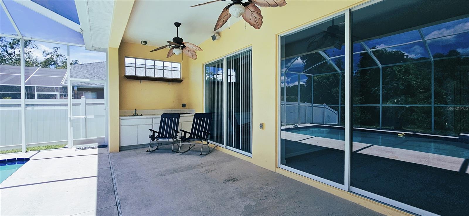 Fully shaded lanai includes ceiling fans and kitchenette