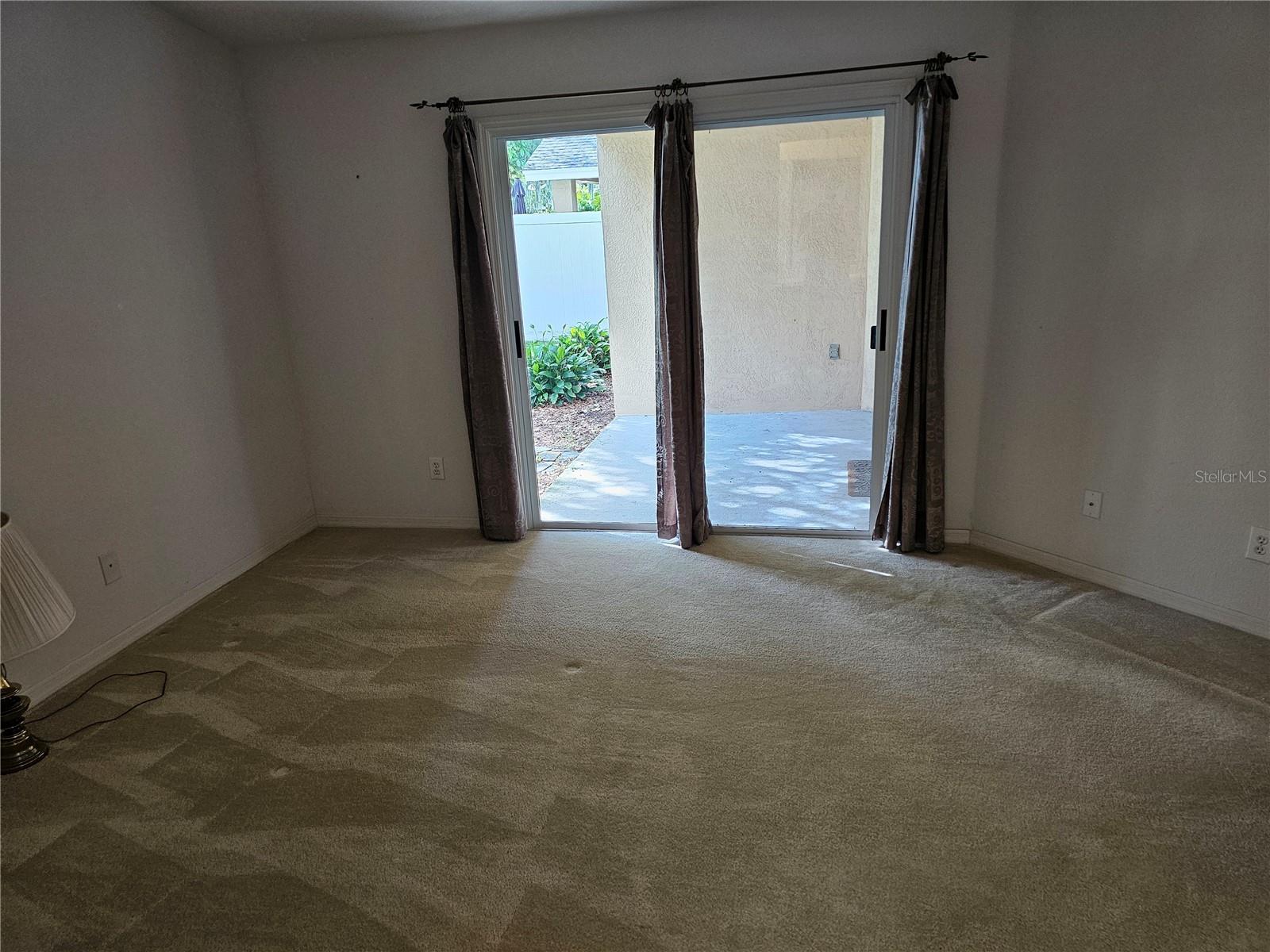 Owners bedroom facing towards patio and access to back yard