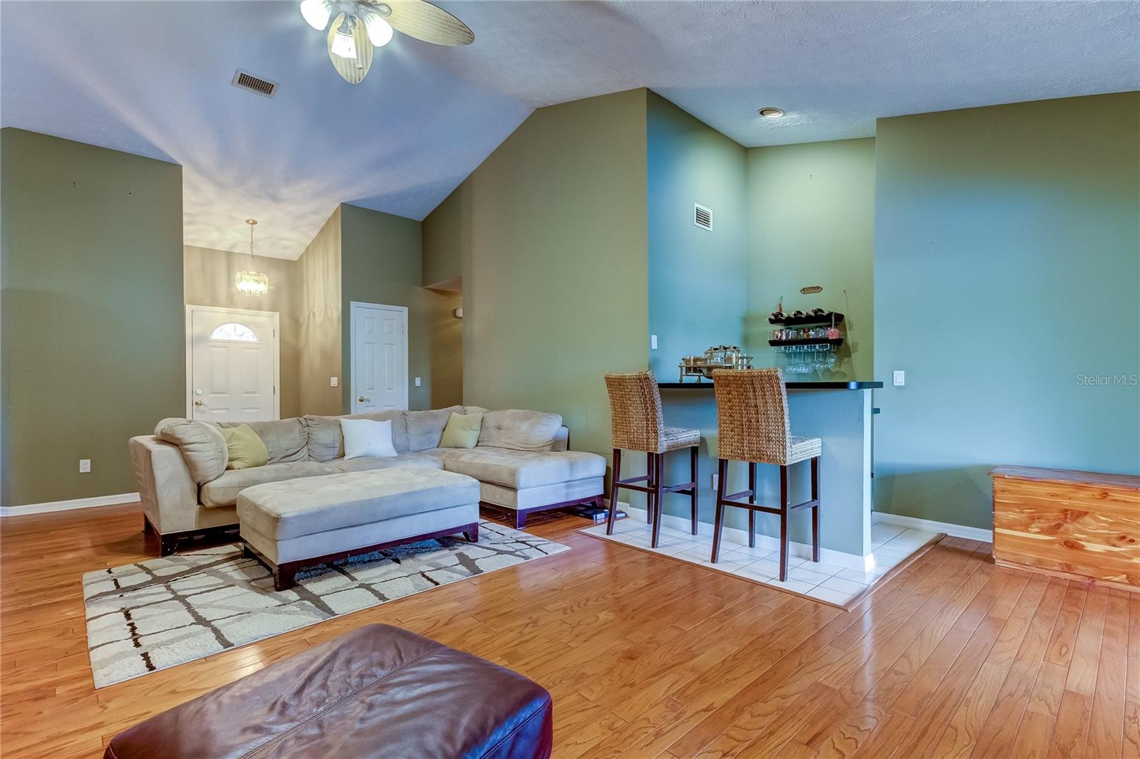 Large living room with vaulted ceilings and a wet bar!