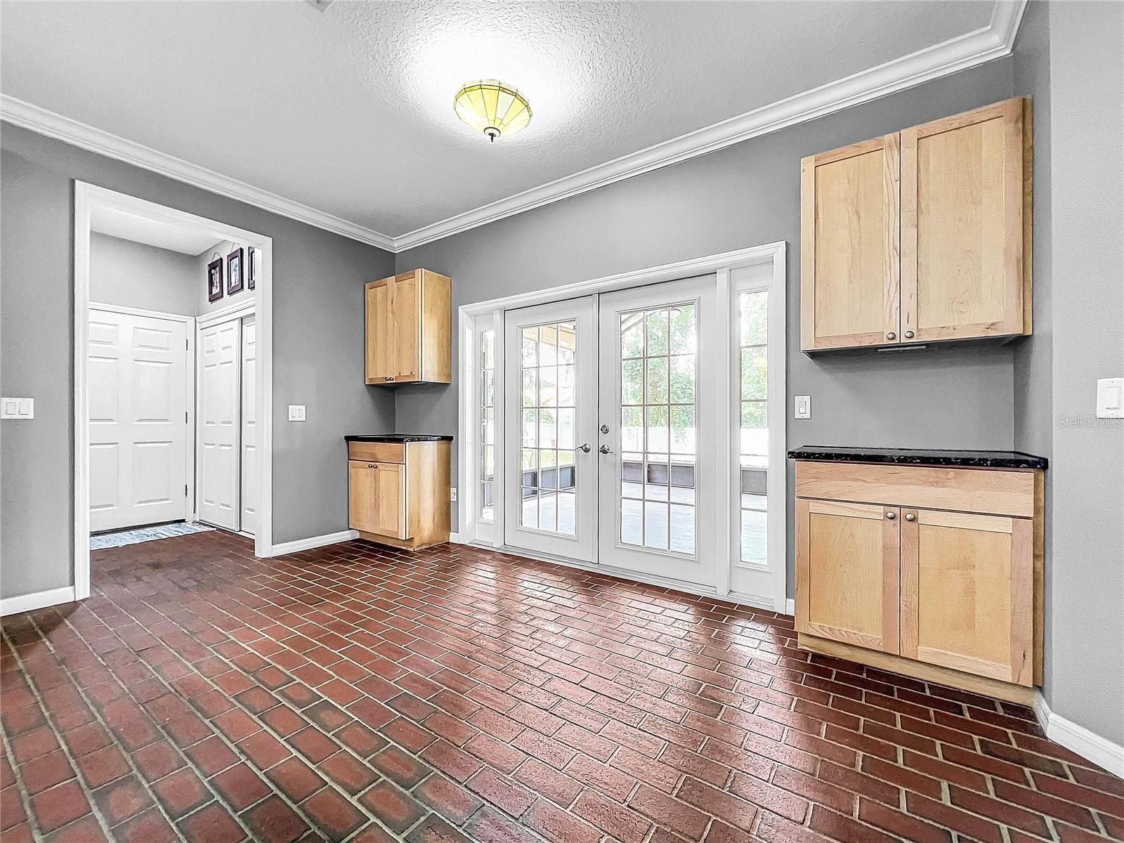 DINING NOOK WITH FRENCH DOORS LEADIN TO THE SCREENED PATIO