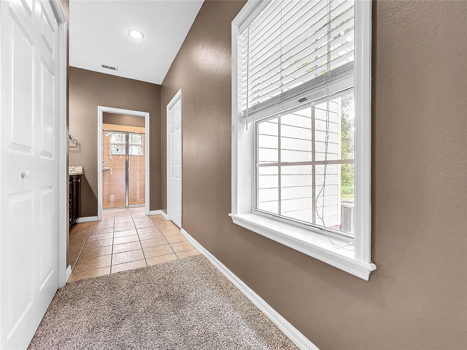 HALL IN PRIMARY SUITE LEADING TO THE DRESSING ROOM & BATHROOM