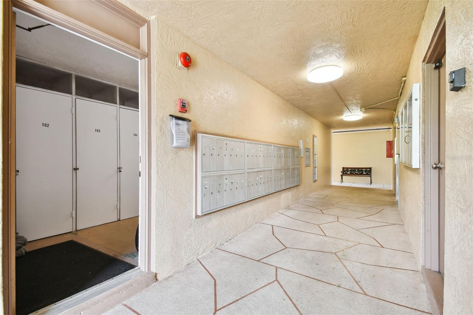 Elevator access, mail boxes, trash room, and storage room on the left