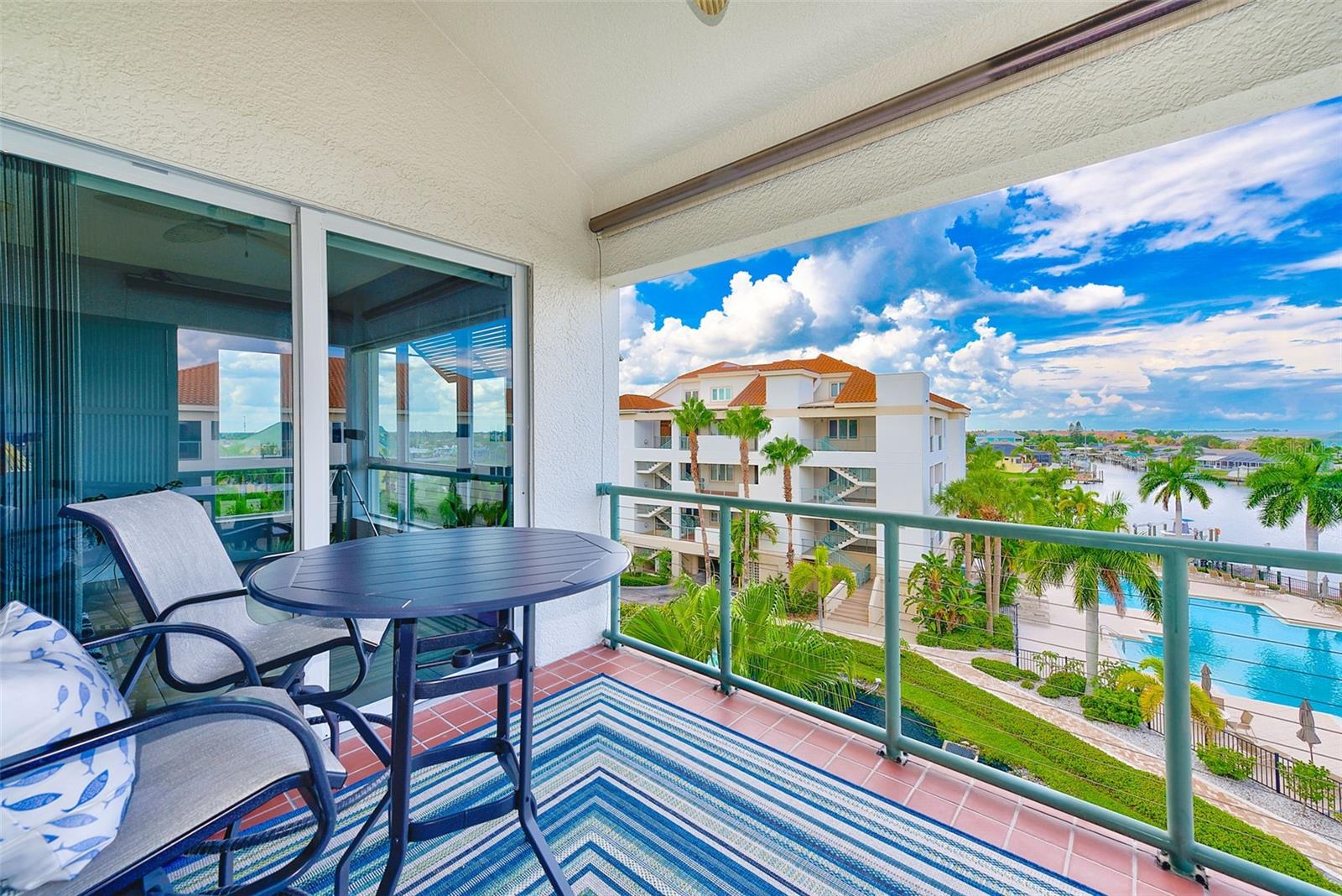 Rear Balcony overlooks pond, pool and water