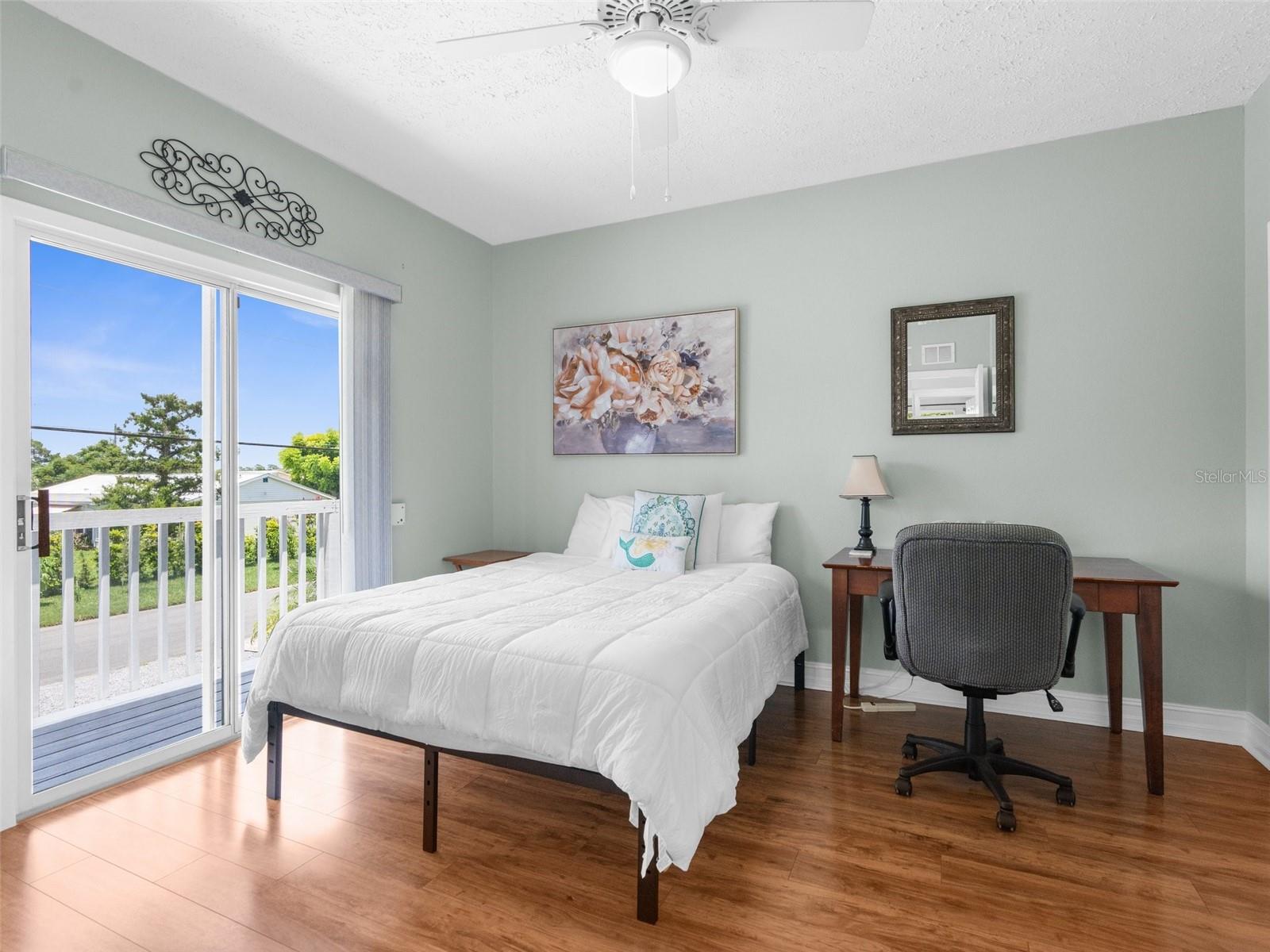 Second bedroom with glass sliders to balcony