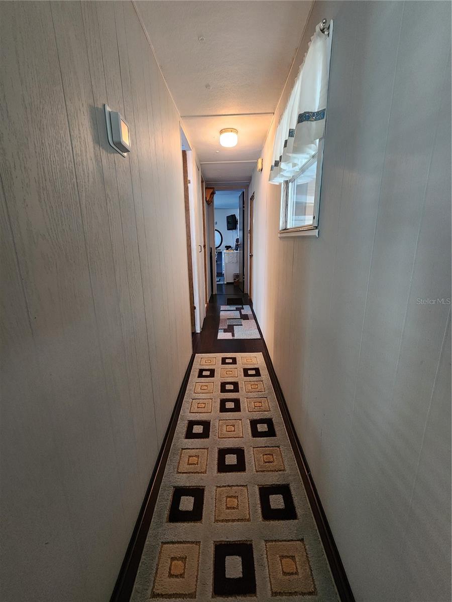 Hallway to bedrooms, bath, & main entry.