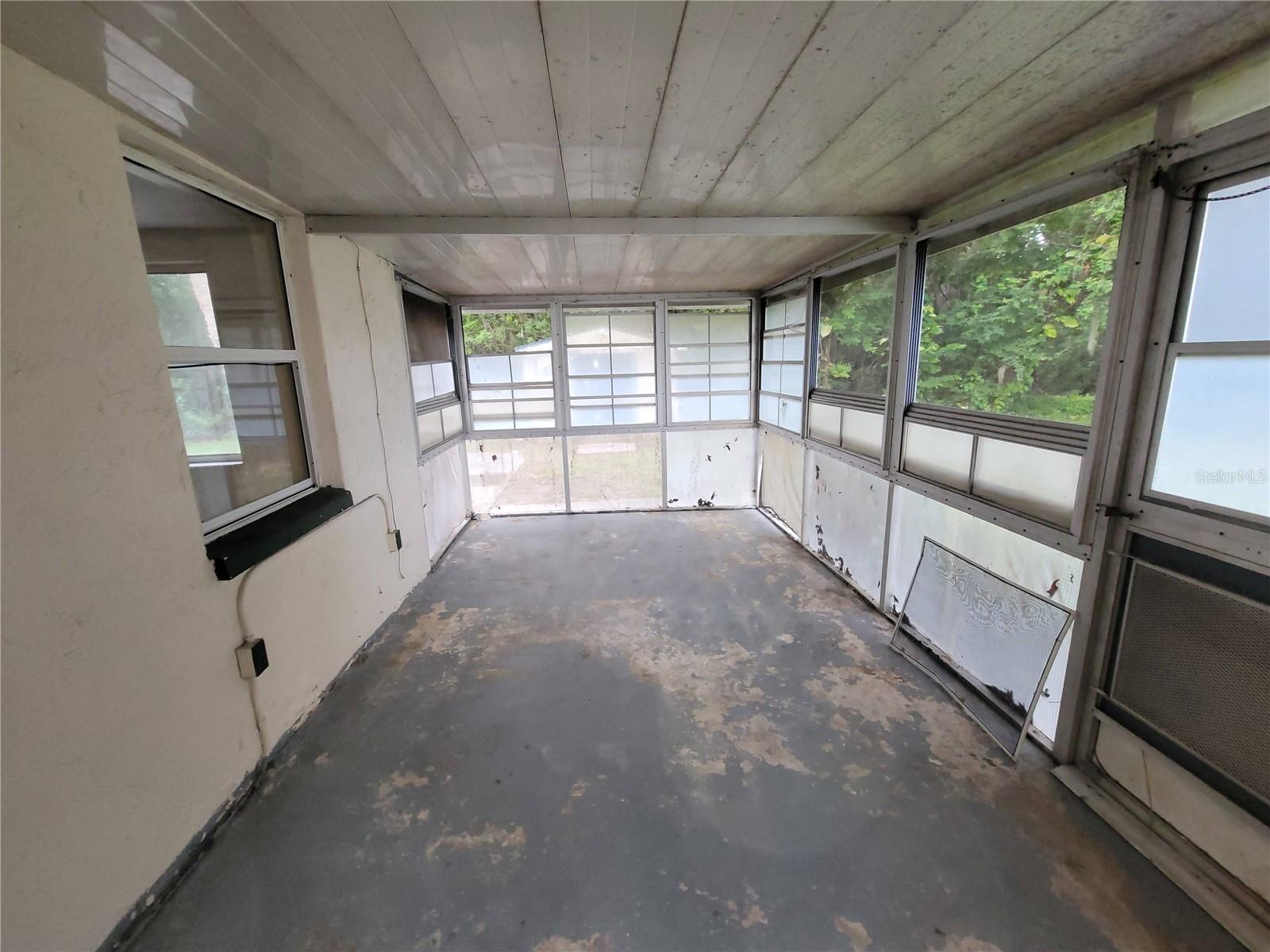 Back screened. vinyl enclosed porch, off of the kitchen eat-in area.